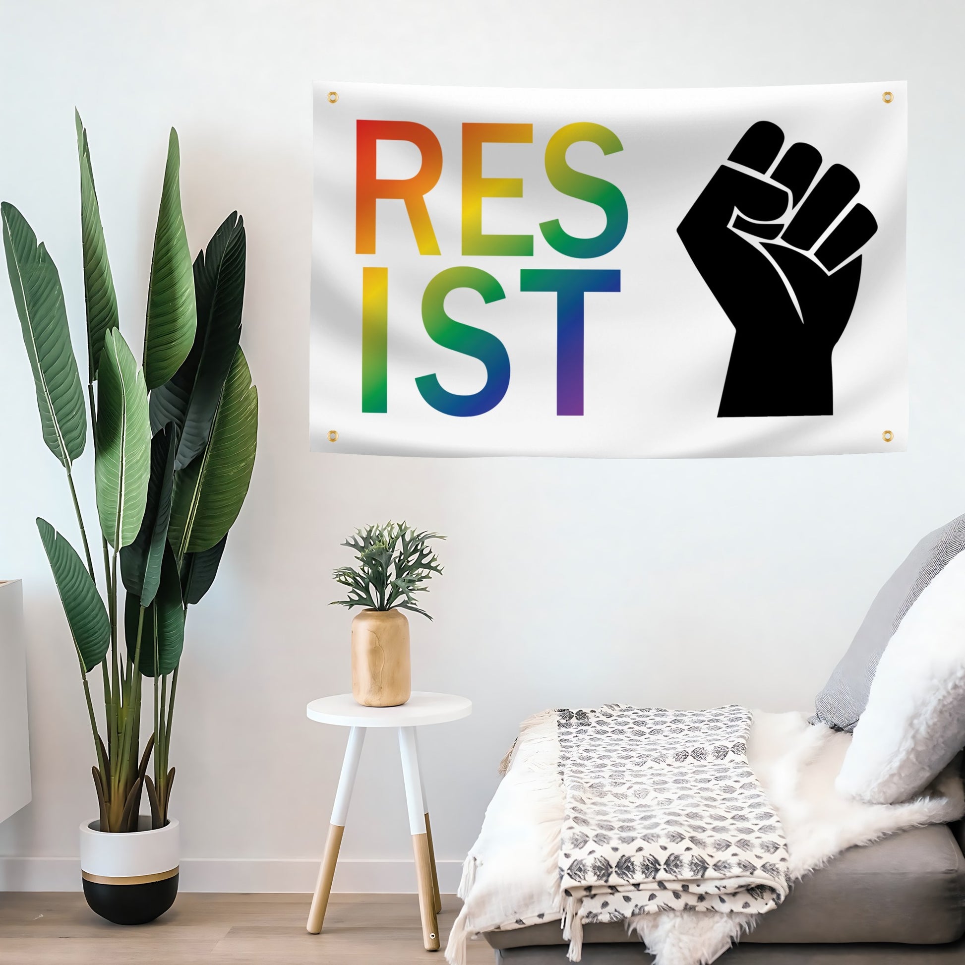 Room interior with a 'RESIST' flag banner featuring a rainbow color scheme and a black fist symbol.