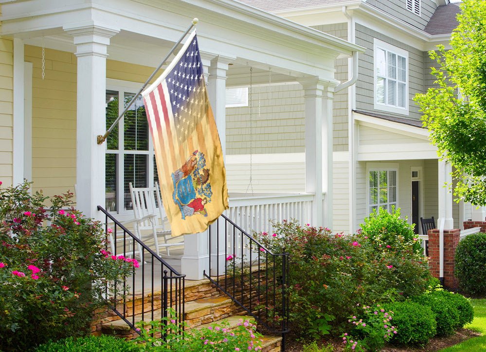 a flag on a porch next to a house