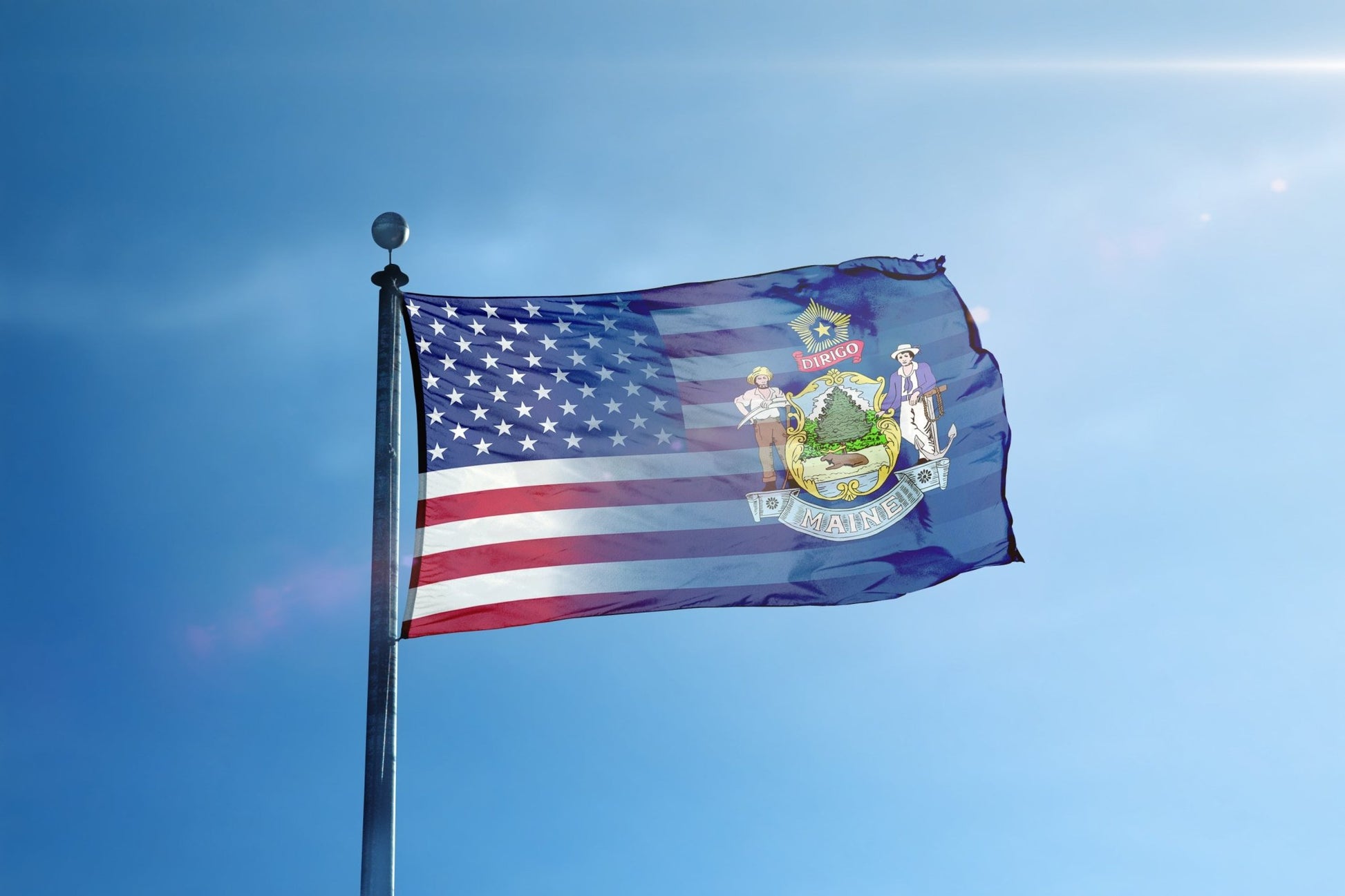 a flag flying in the wind with a blue sky in the background