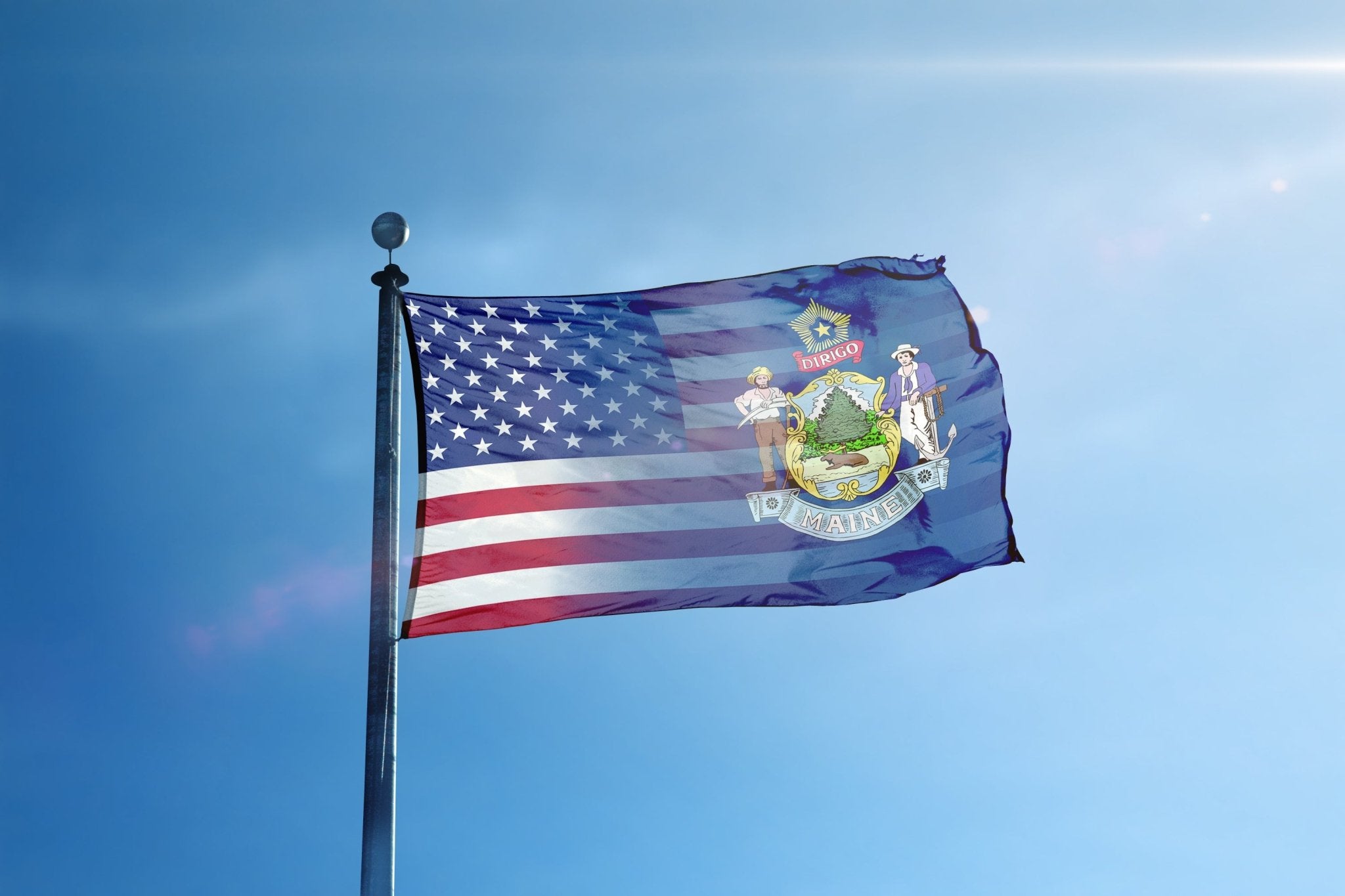 a flag flying in the wind with a blue sky in the background