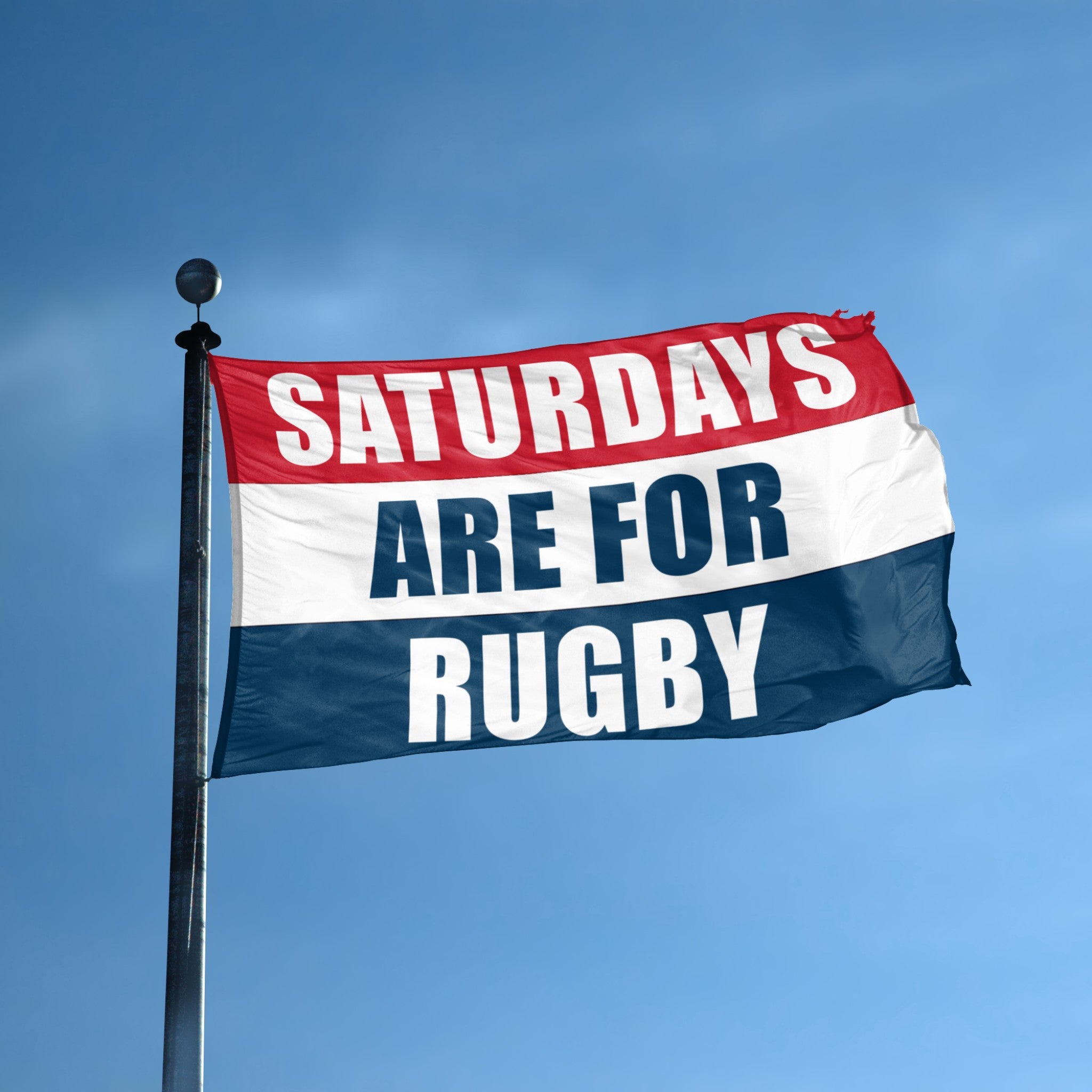 Saturdays are for rugby flag in red, white and blue flying on a flagpole. 