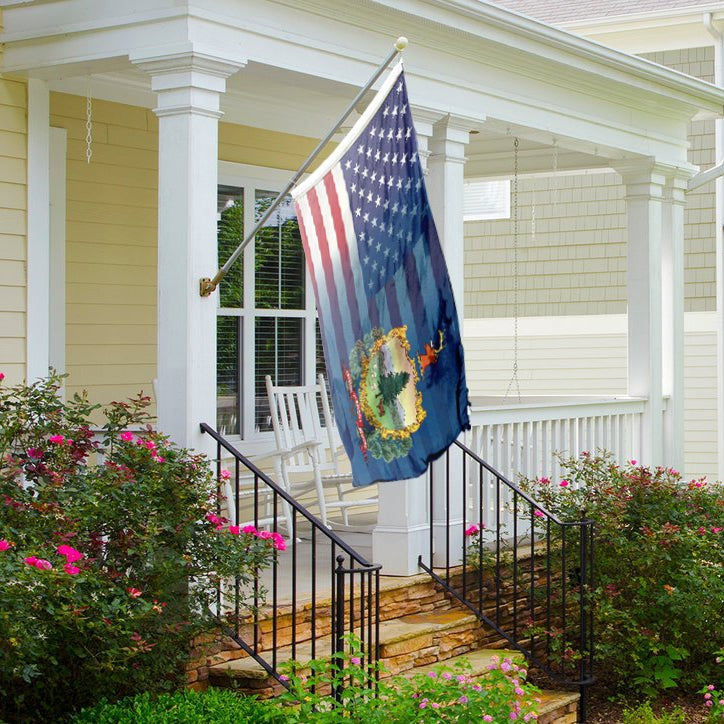Flag of Vermont blended with the American flag on a front porch flagpole.