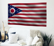 Load image into Gallery viewer, a living room with a guitar and a flag on the wall
