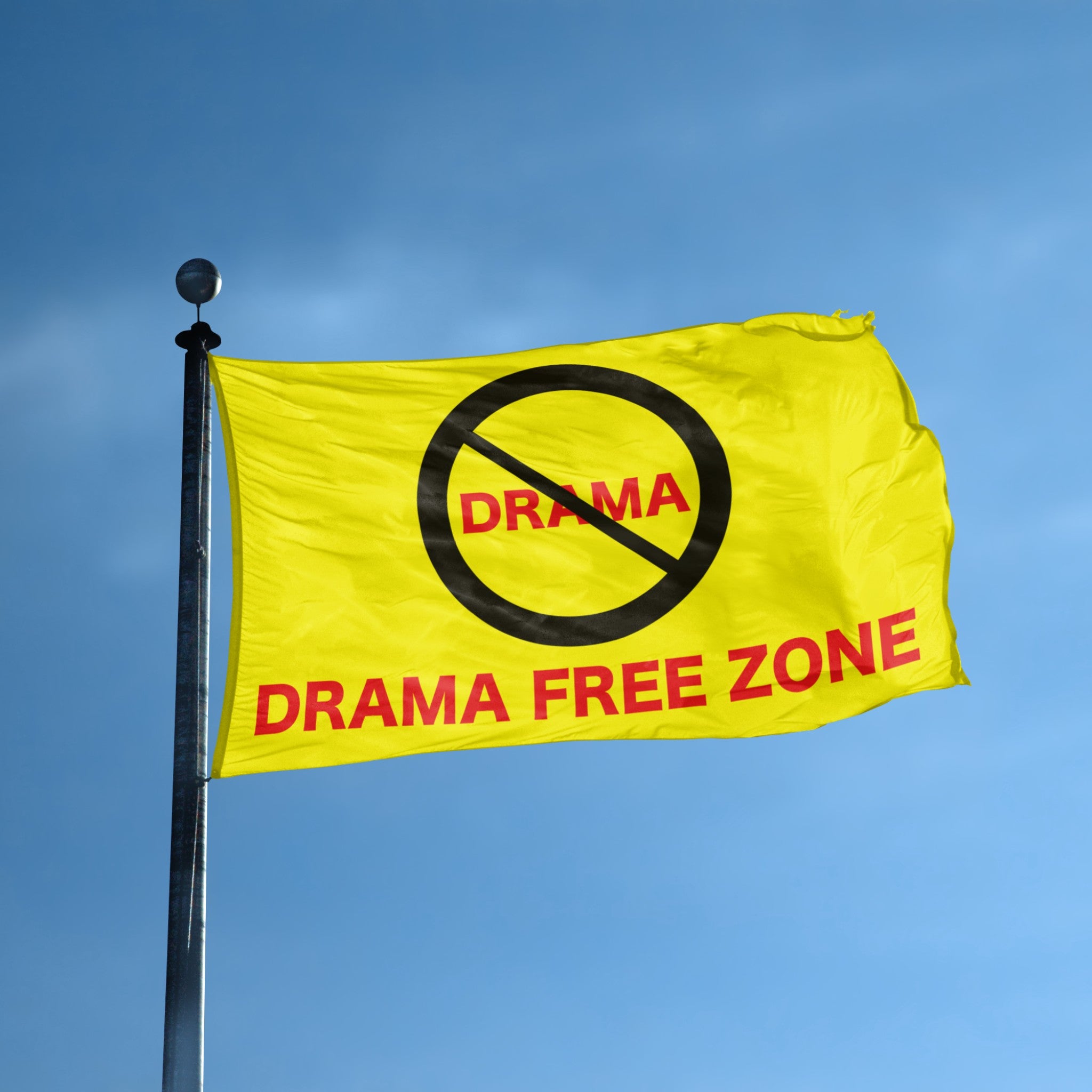 Yellow flag with 'Drama Free Zone' text against a blue sky