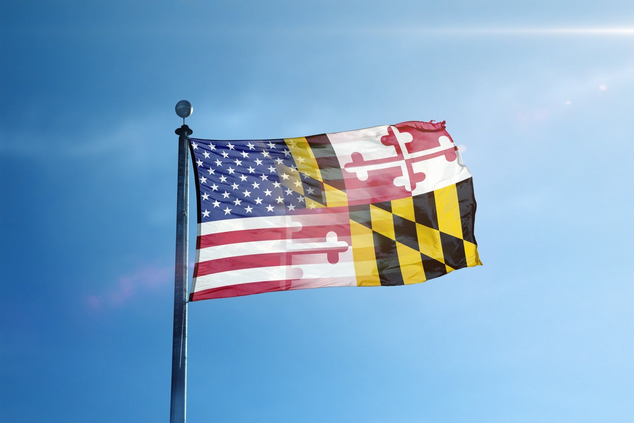 a flag flying in the wind with a blue sky in the background