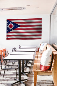 a long table with chairs and a flag hanging on the wall