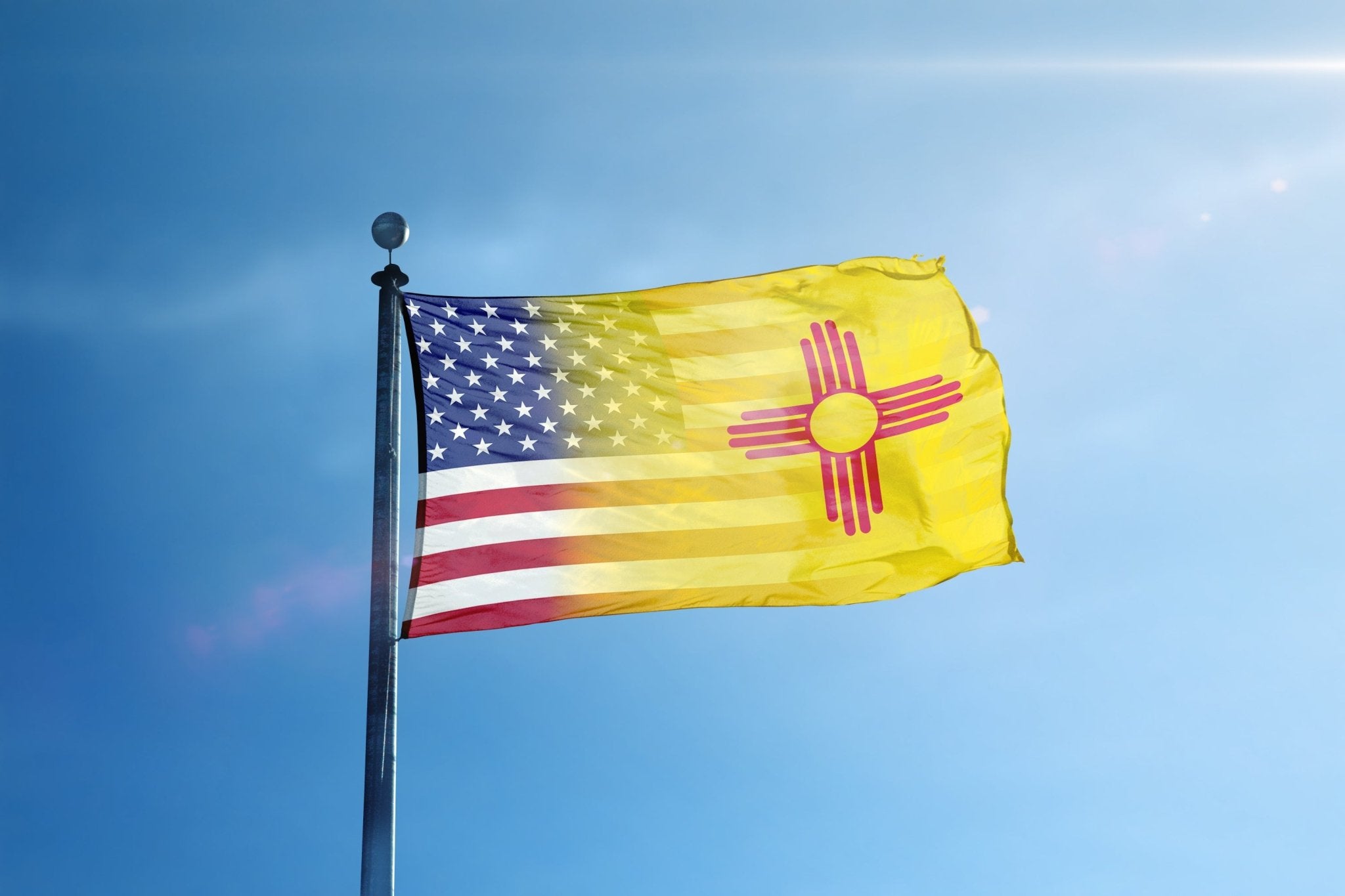 a flag flying in the wind with a blue sky in the background