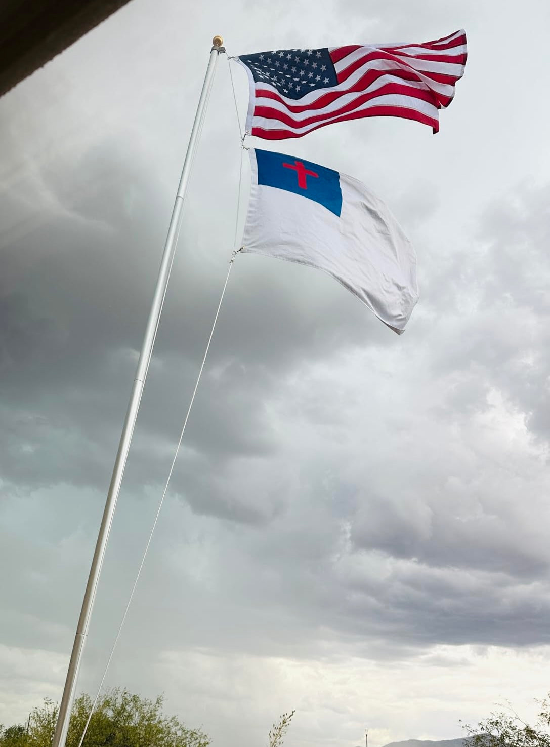 American flag and christian flag displayed on outdoor flagpole using halyard rope kit with swivel clips for dual flag mounting