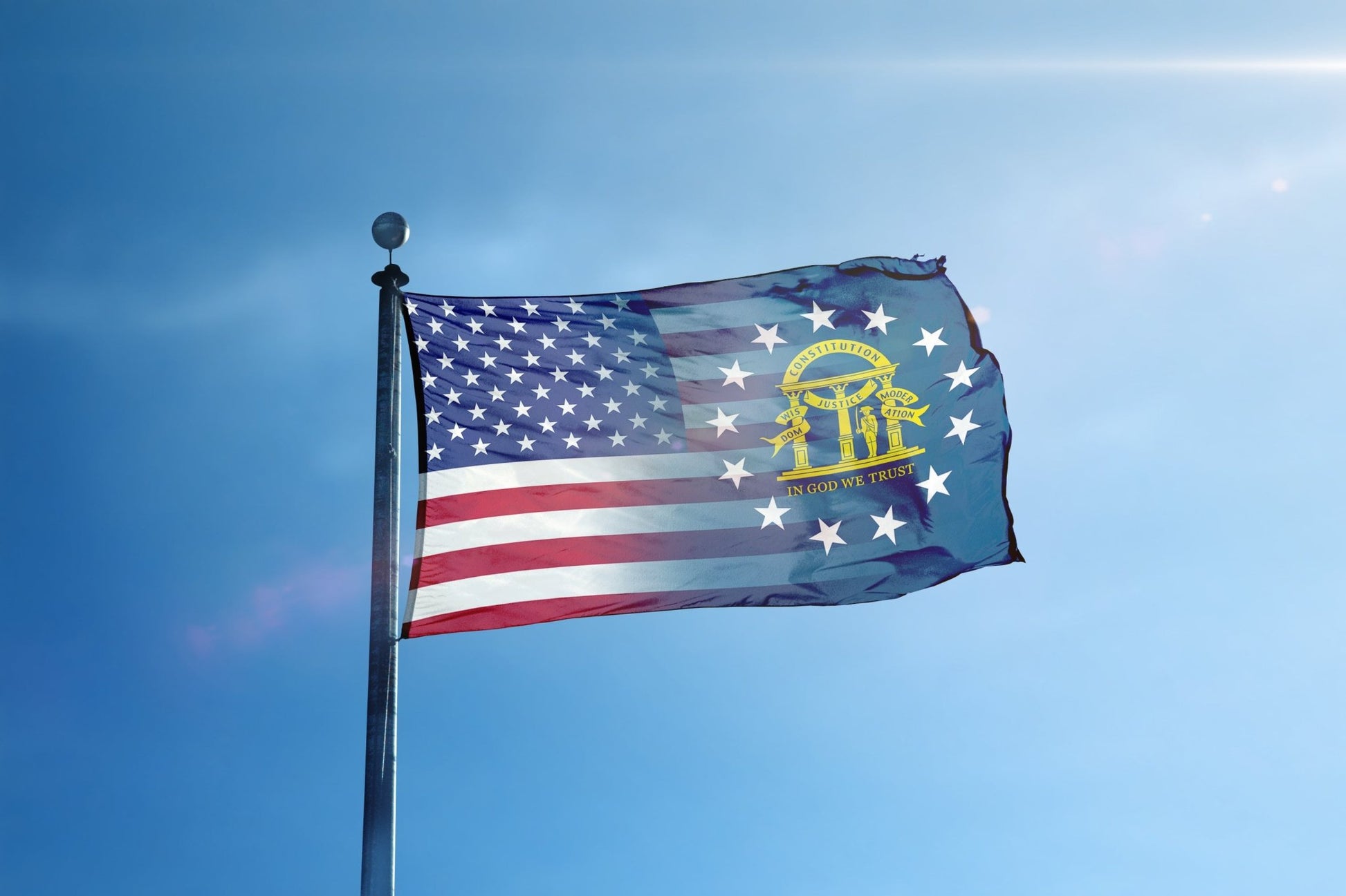 a flag flying in the wind with a blue sky in the background