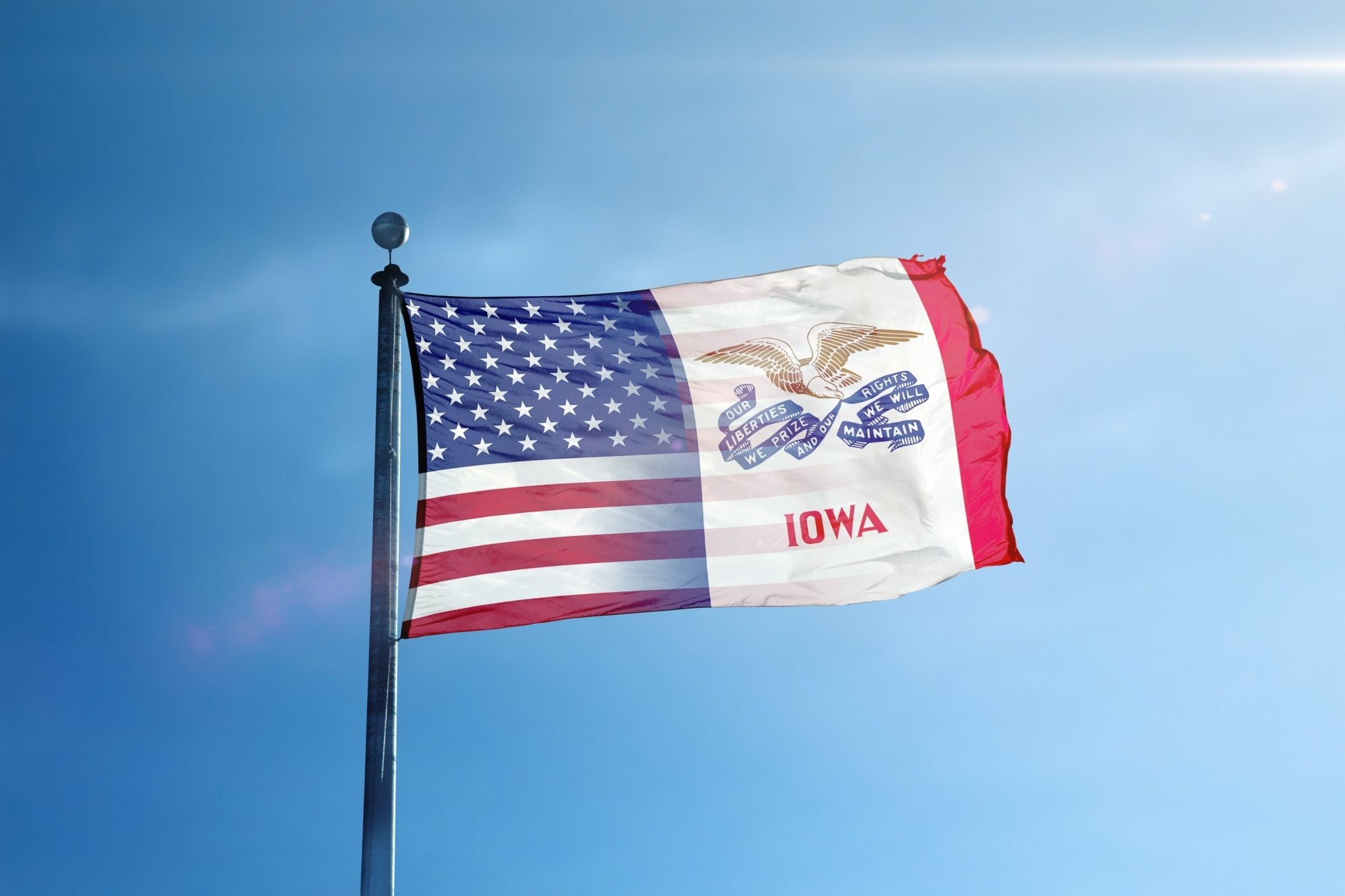 a flag flying in the wind with a blue sky in the background