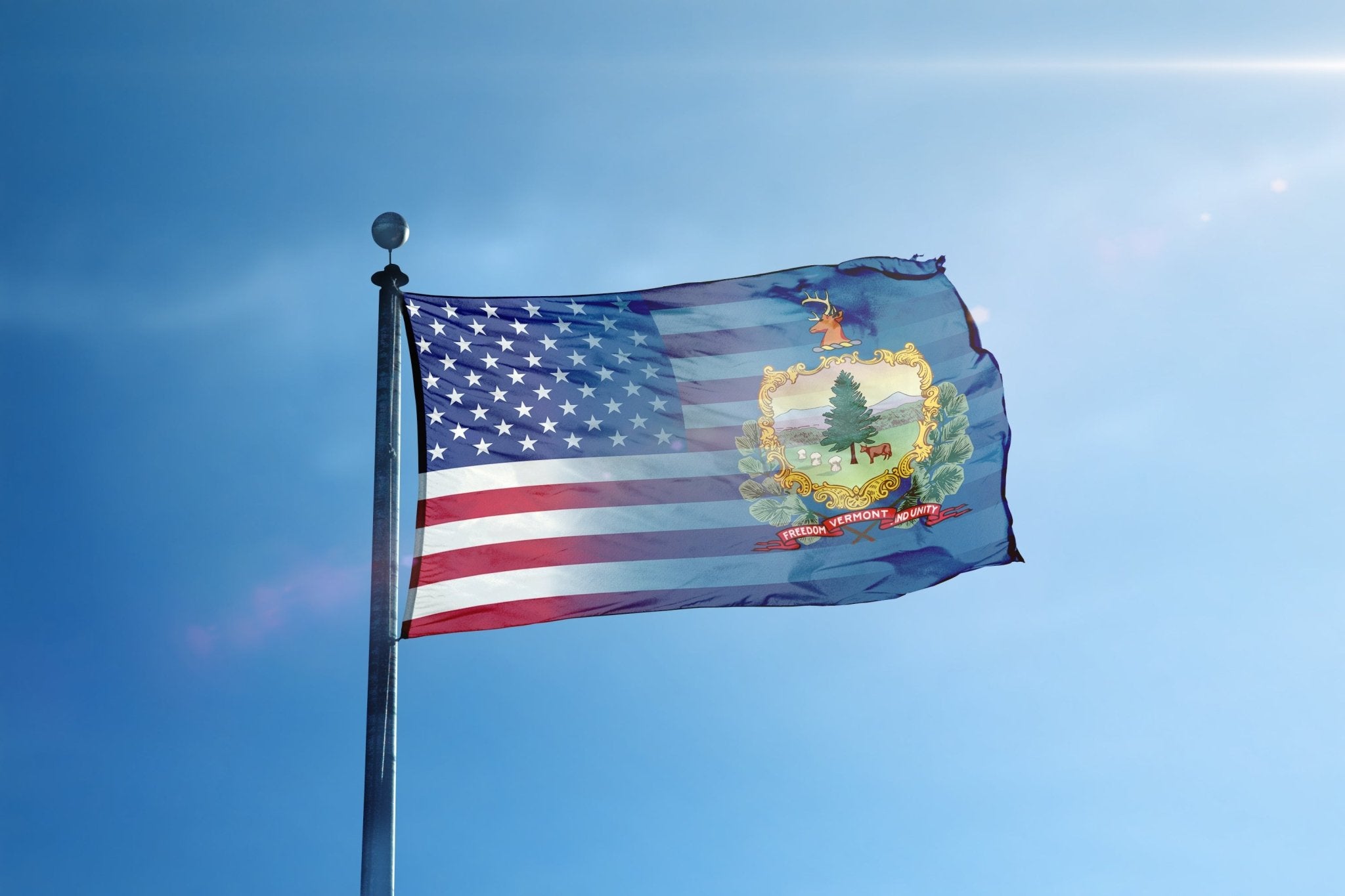 a flag flying in the wind with a blue sky in the background