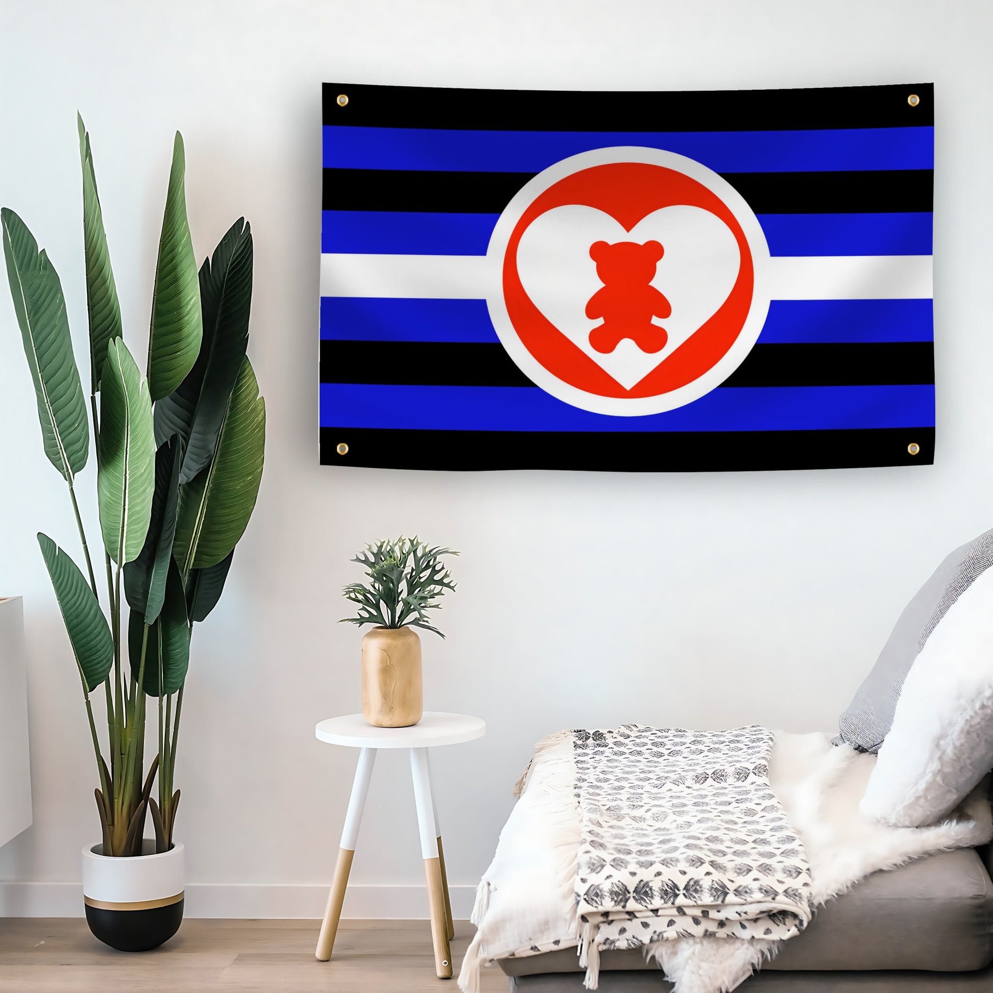 DDLG Flag with blue, black, and white stripes and a red heart with a bear inside on a living room wall.