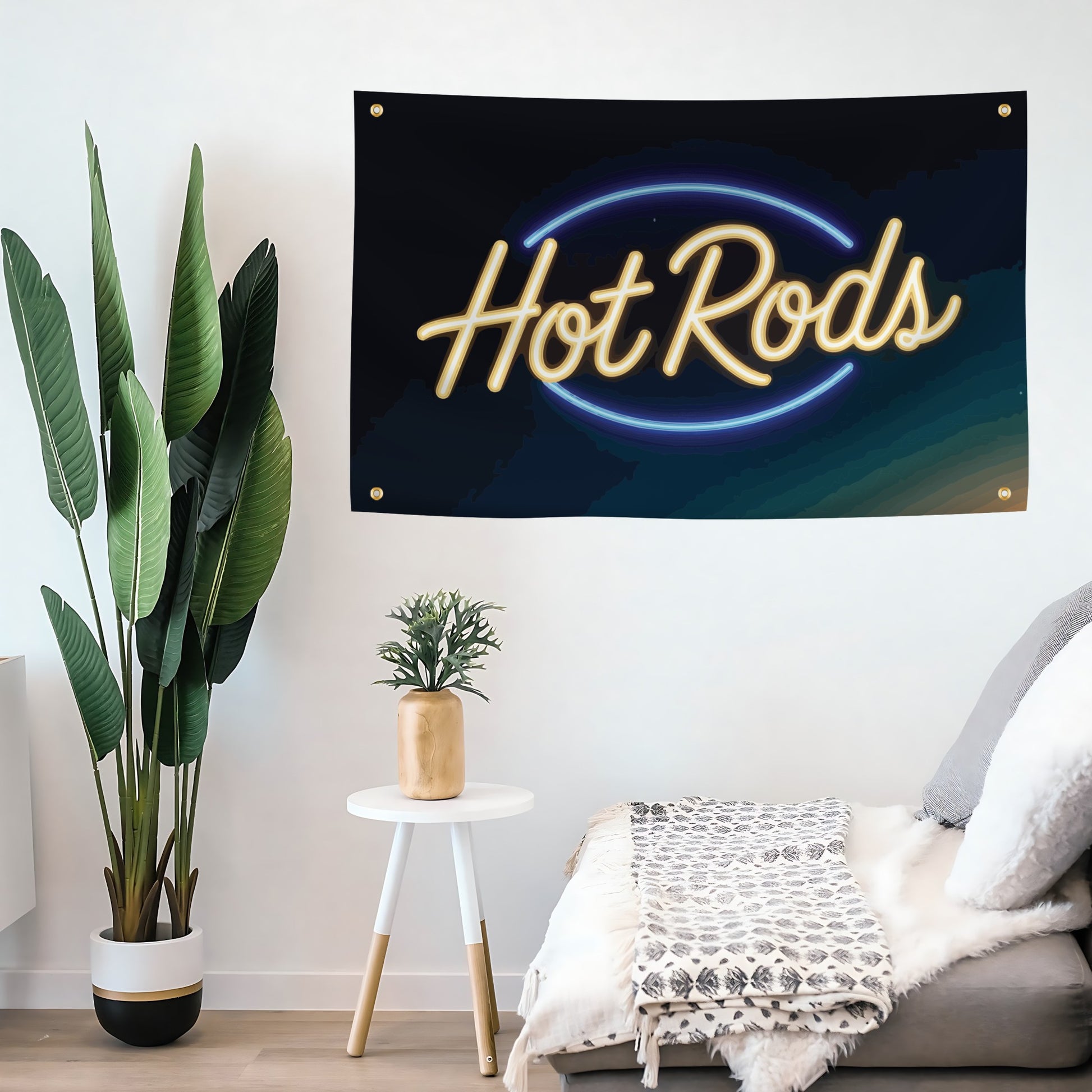 Neon-style 'Hot Rods' banner hanging on a wall above a sofa with decorative plants.