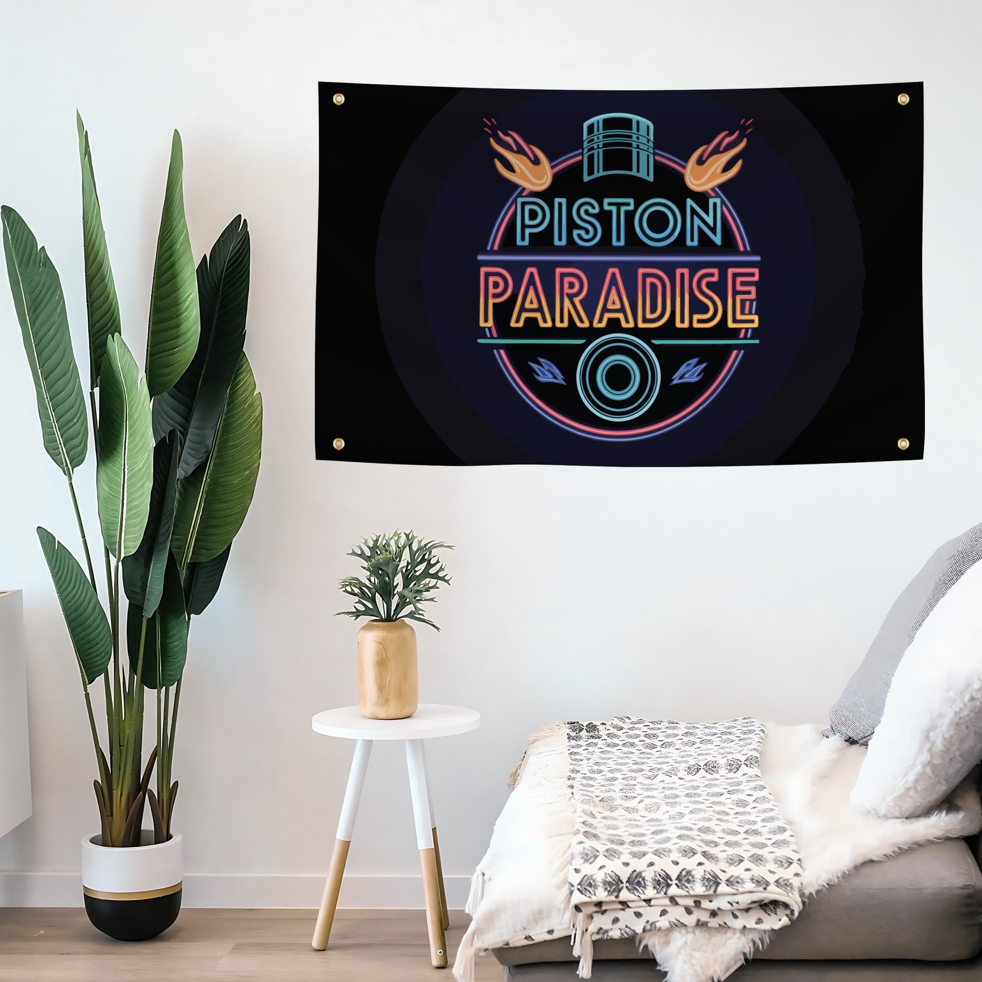 Neon-style 'Piston Paradise' sign on a wall above a sofa with decorative plants.