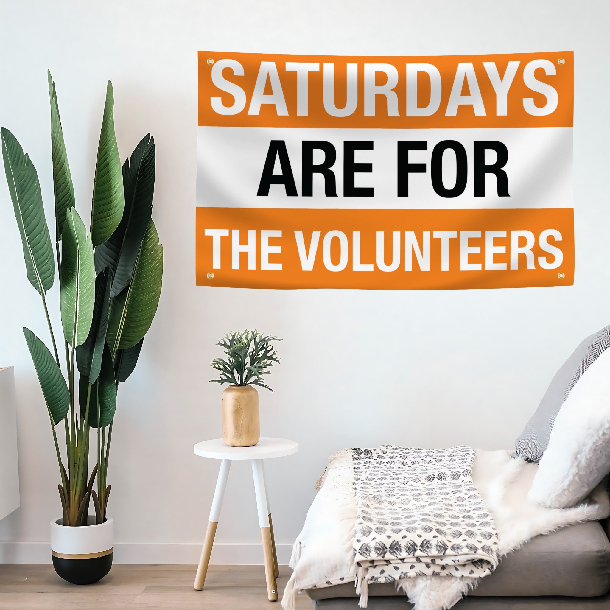 Living room with a motivational flag banner on the wall reading 'Saturdays are for the volunteers'.