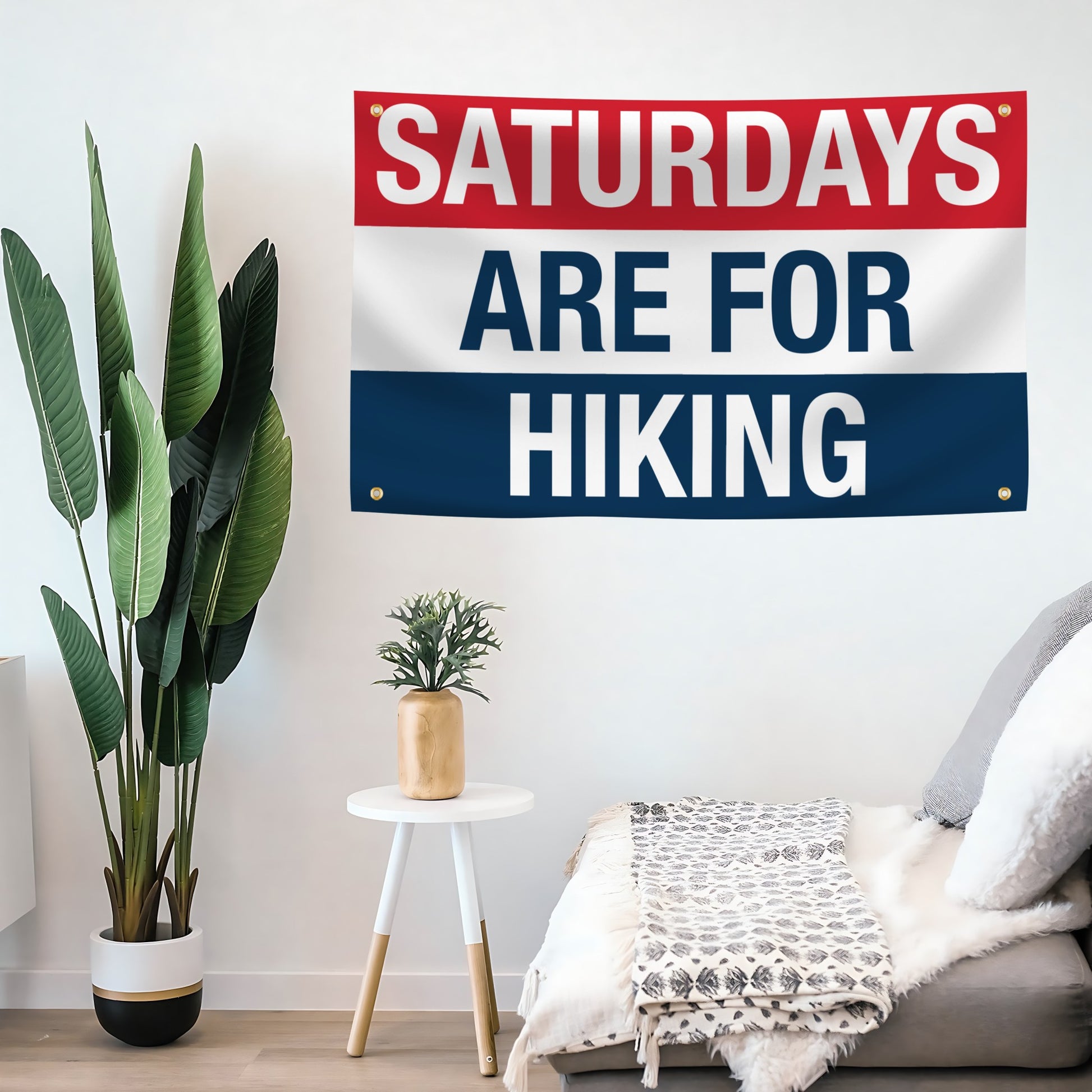 Decorative flag banner with 'Saturdays are for Hiking' text in a room with plants and furniture.
