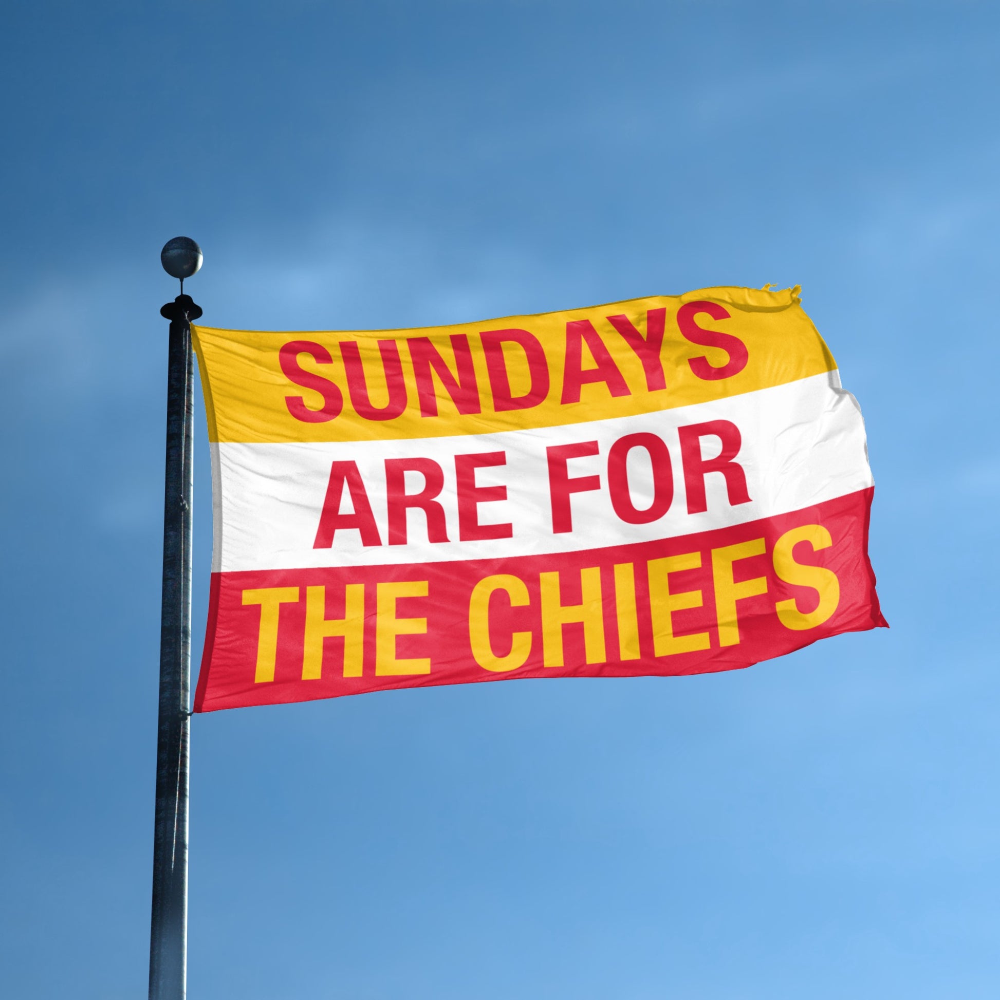 Flag with 'Sundays are for The Chiefs' text against a blue sky