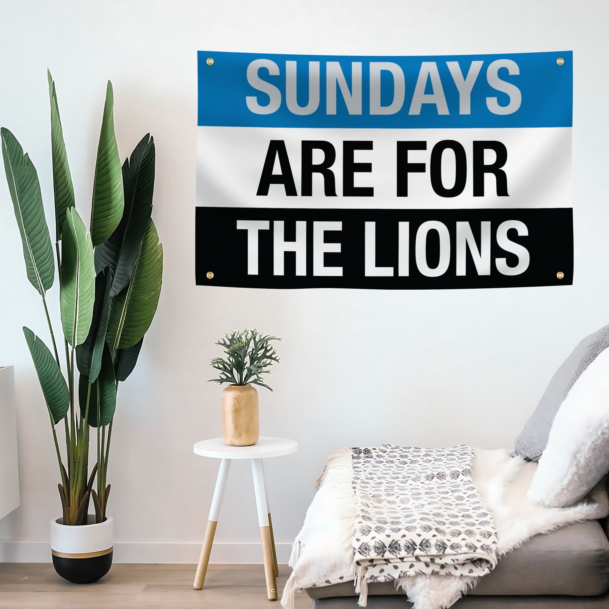 A banner with white text that reads 'SUNDAYS ARE FOR THE LIONS' on a living room wall. 