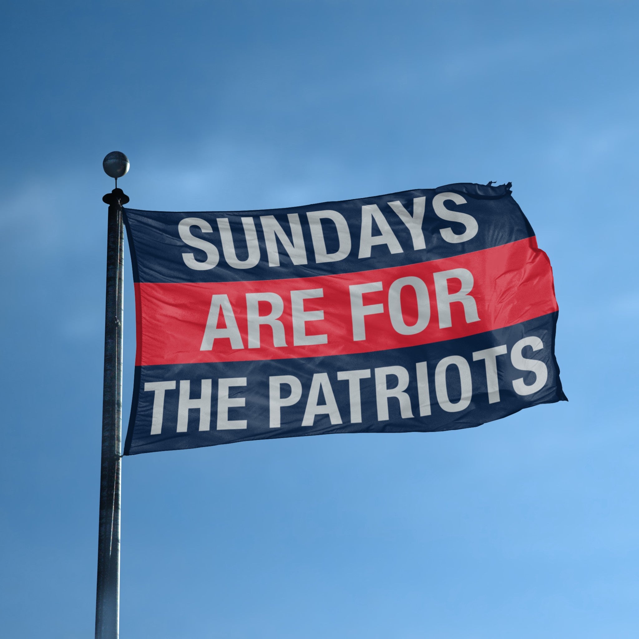 Flag with 'Sundays are for the Patriots' text against a blue sky