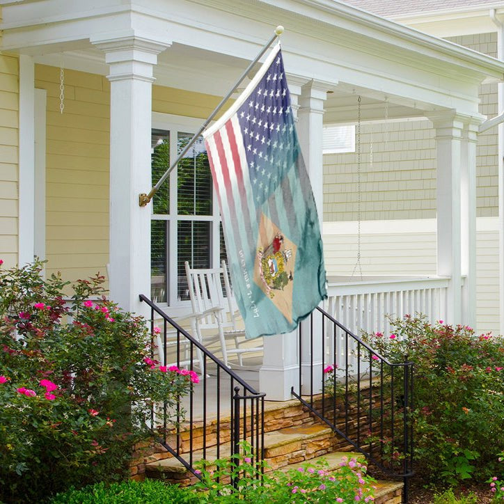 Flag with American stars and stripes and Delaware state symbols on a front porch
