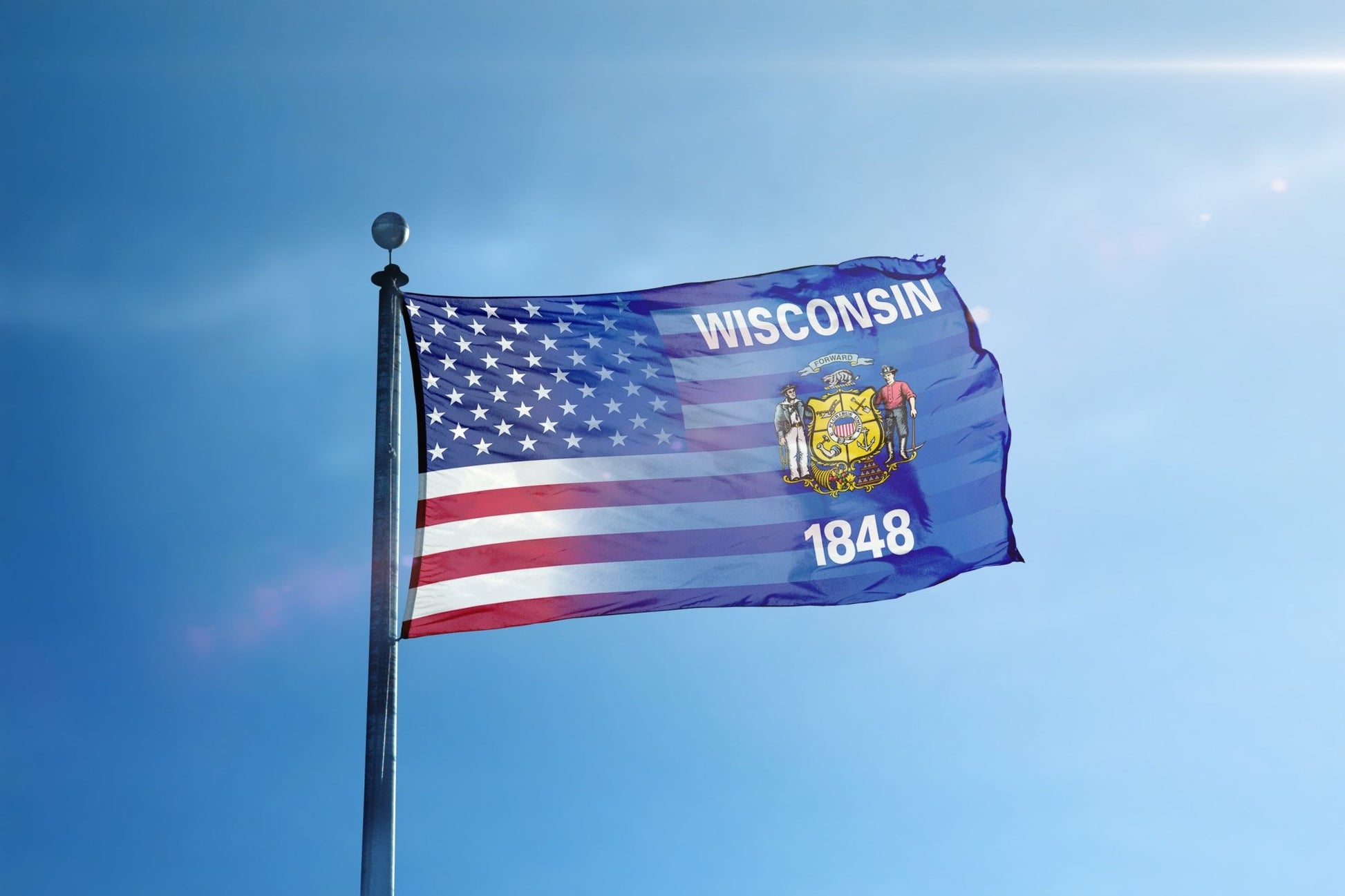 a flag flying in the wind with a blue sky in the background