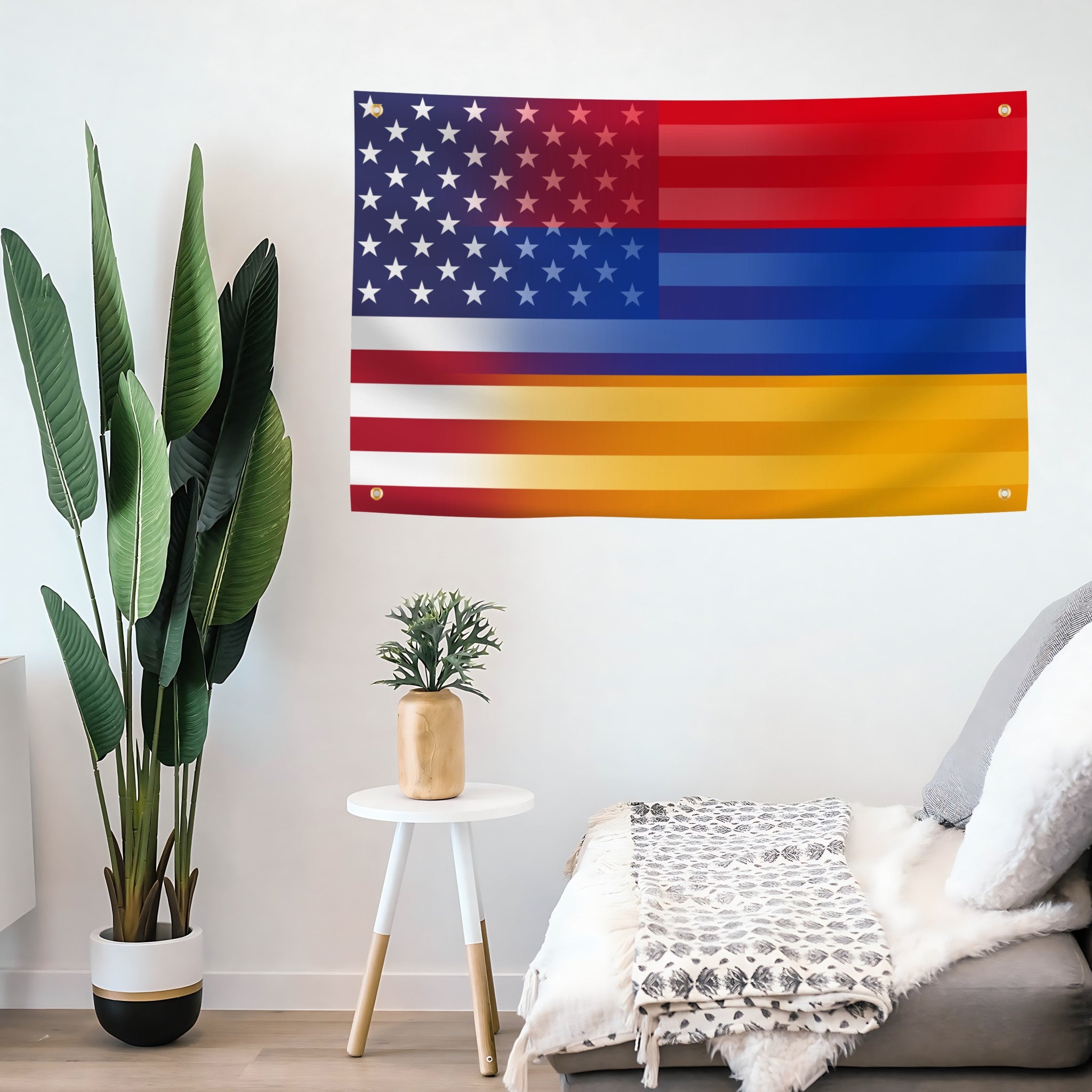 A flag banner featuring a stylized American flag design with red, white, and blue stripes and stars, hanging on a white wall in a modern living room setting next to a potted plant and a sofa.