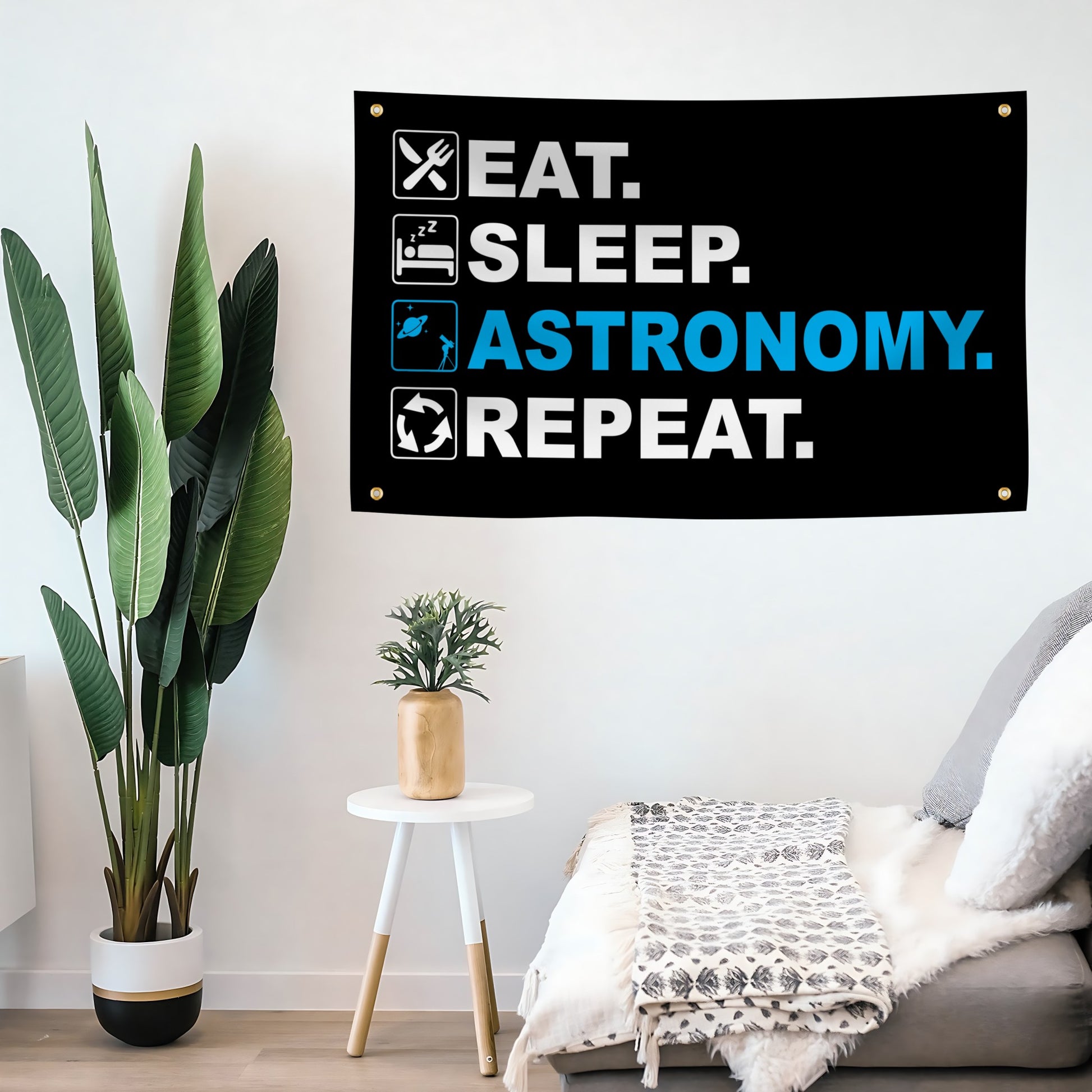 Living room with a 'Eat. Sleep. Astronomy. Repeat.' flag banner on the wall.