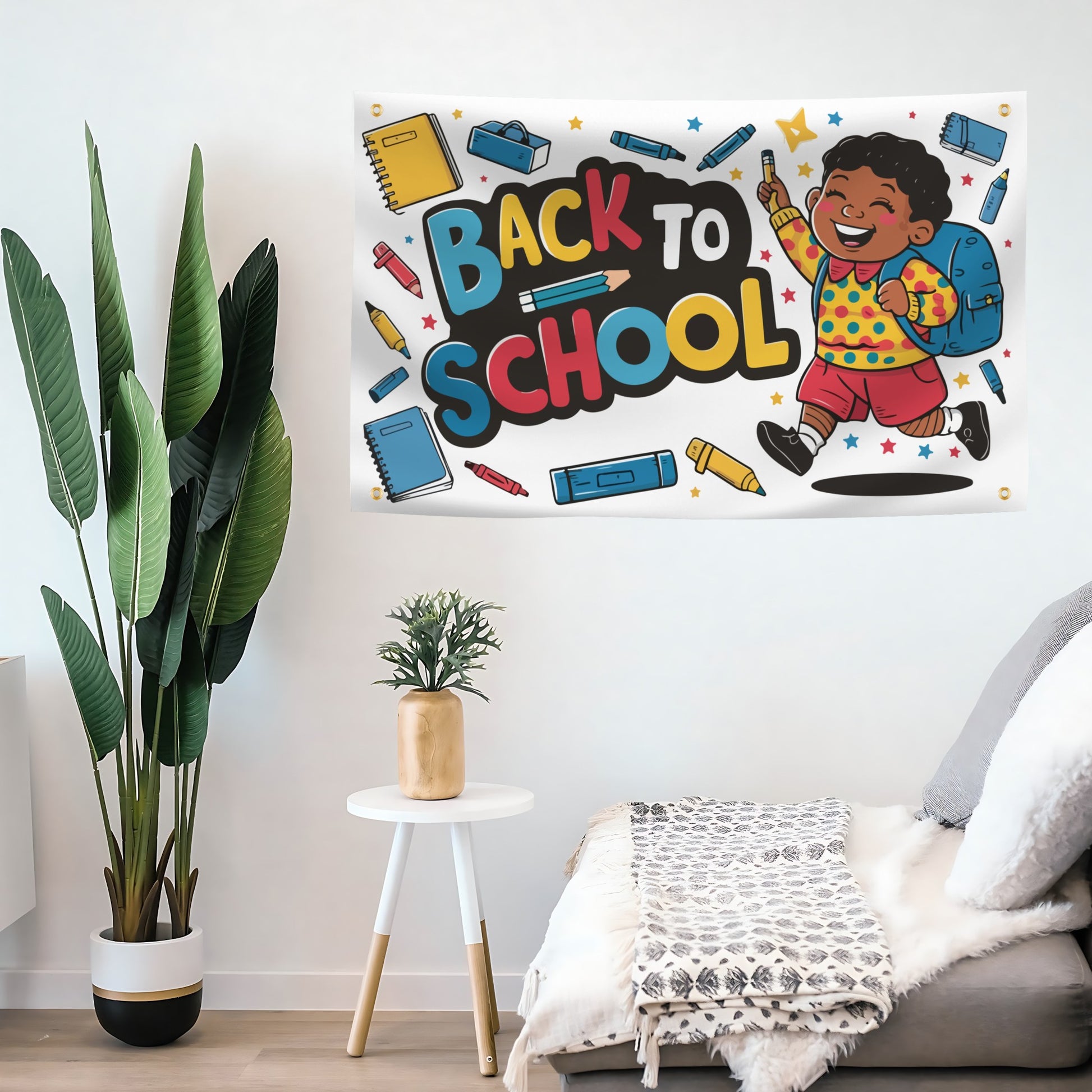 A colorful 'Back to School' flag banner featuring a cartoon child with a backpack and school supplies, displayed on a white wall in a styled room with a plant, side table, and sofa.