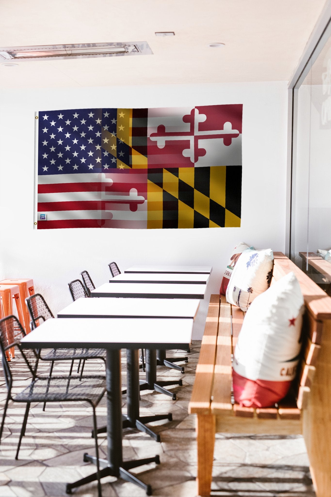 a room with tables and chairs and a flag hanging on the wall