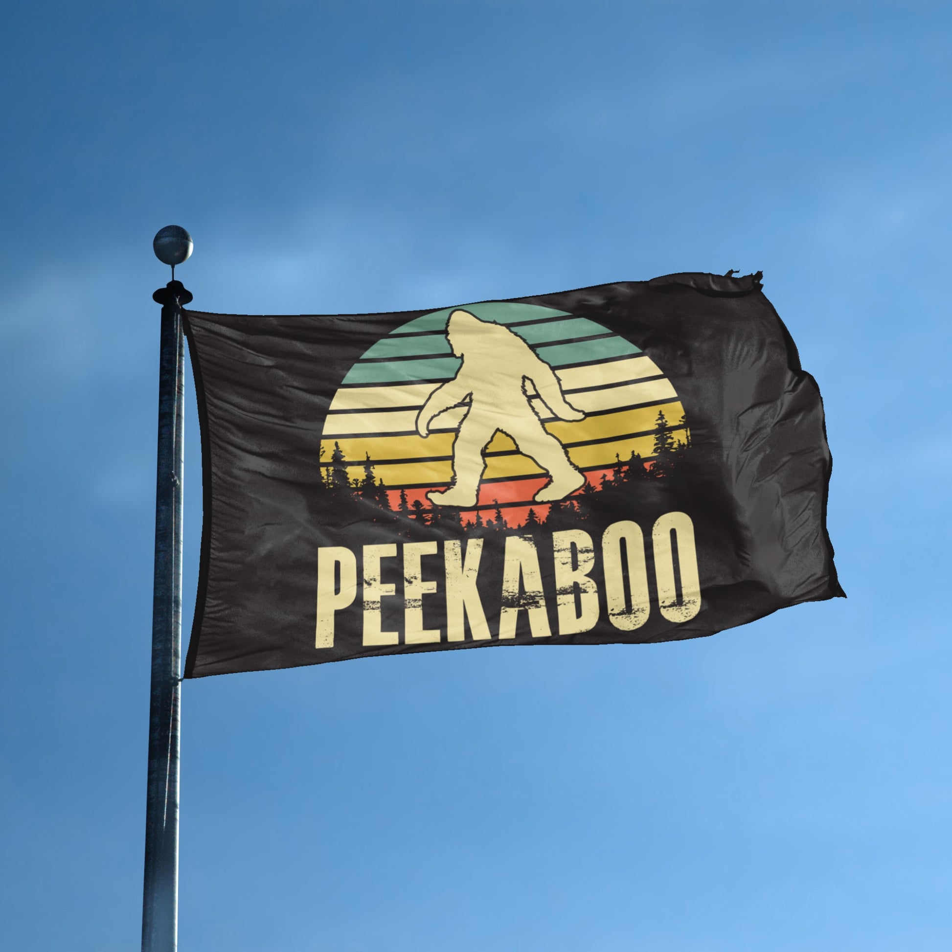 A flag with the theme "Bigfoot Peekaboo" displayed on a tall flag pole and blue skies.