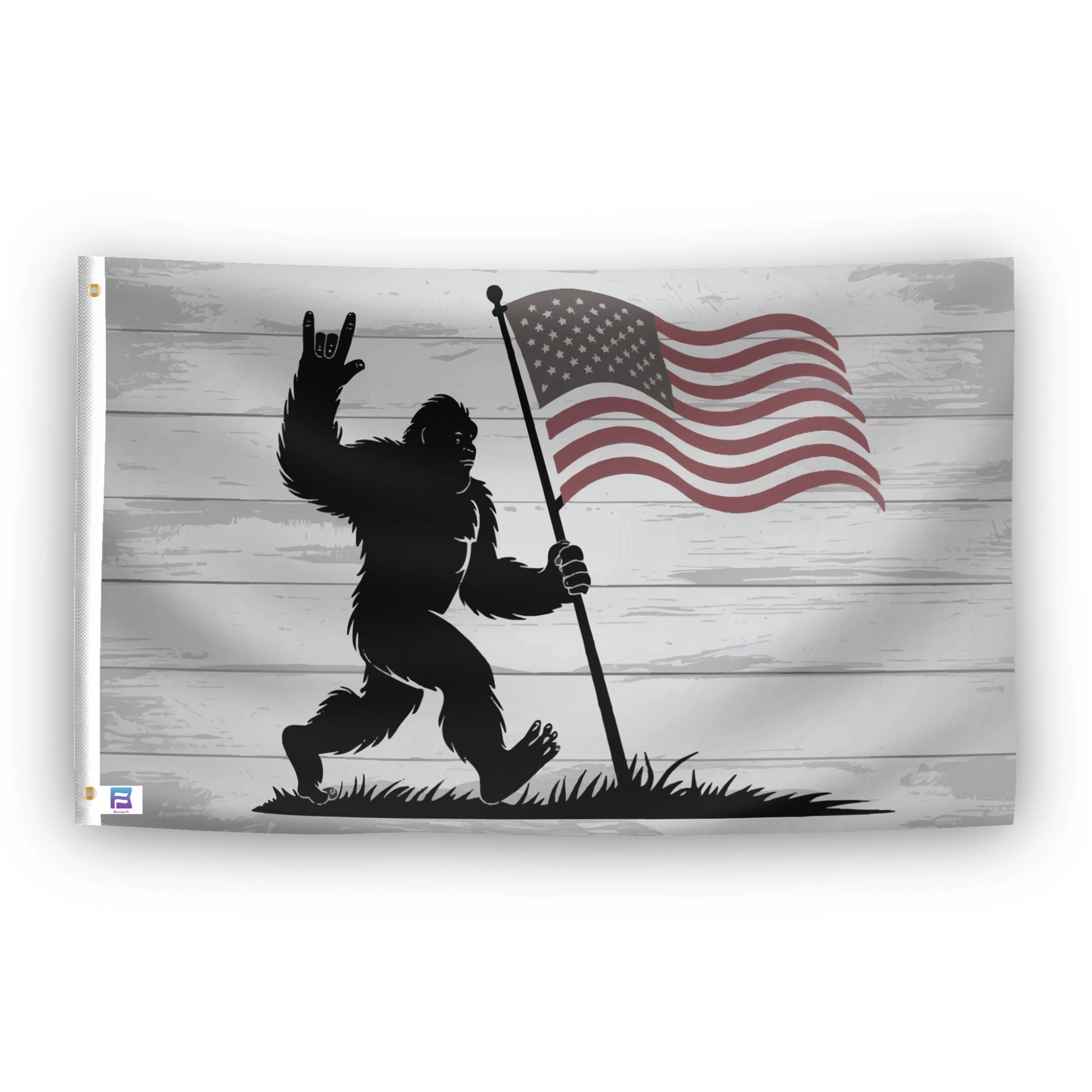 A flag with the theme "Bigfoot Rock On Patriotic", displayed with two brass grommets reinforced with a white canvas header.