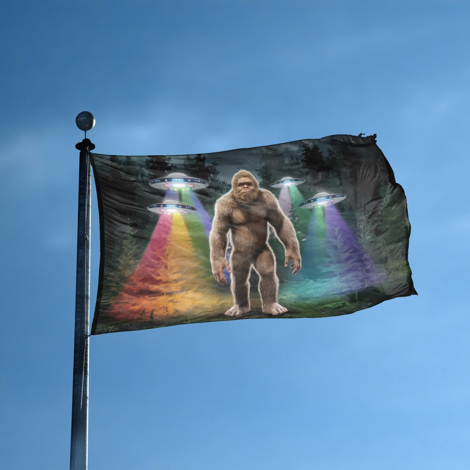 A flag with the theme "Bigfoot UFO" displayed on a tall flag pole and blue skies.