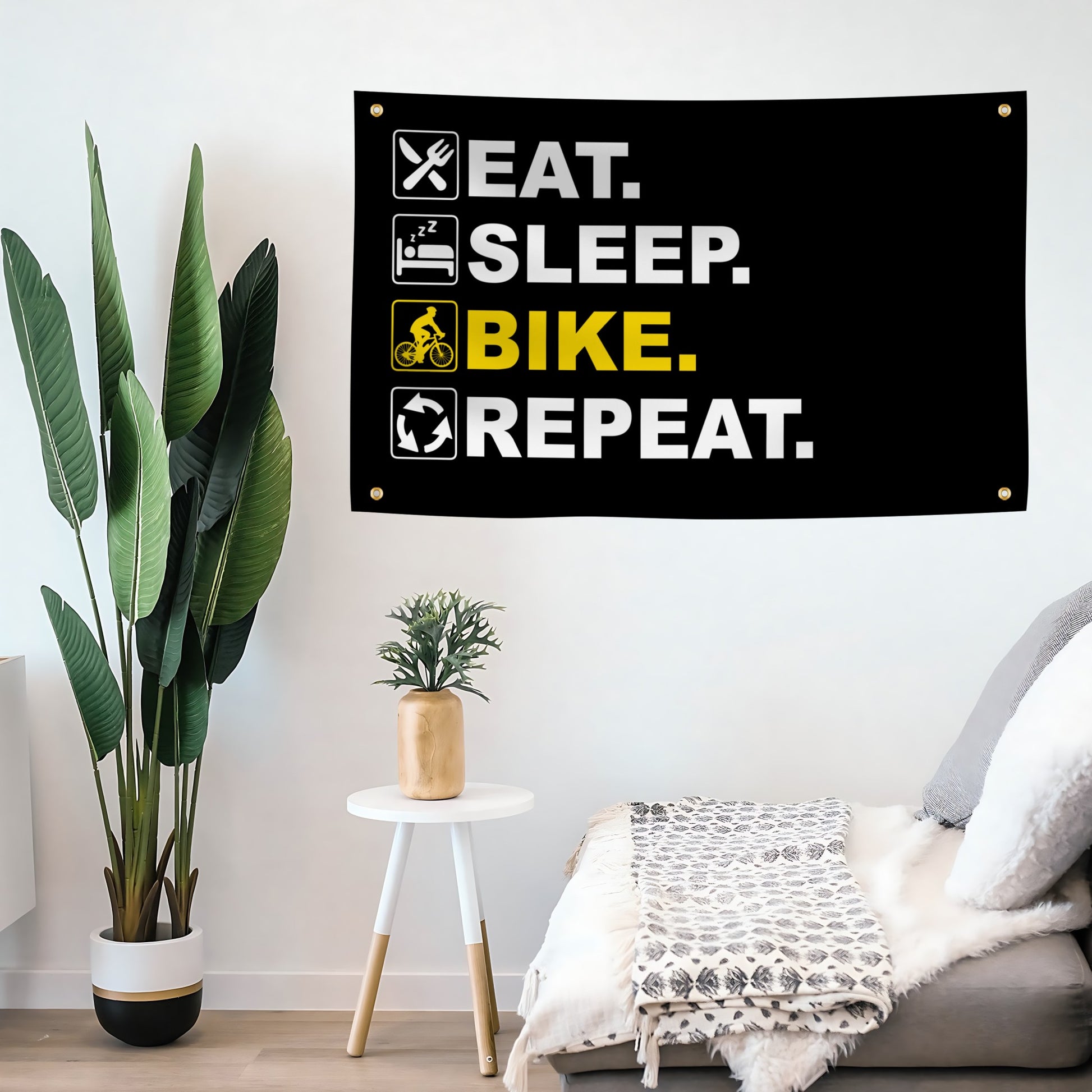 Motivational flag banner with 'Eat. Sleep. Bike. Repeat.' text in a modern living room.