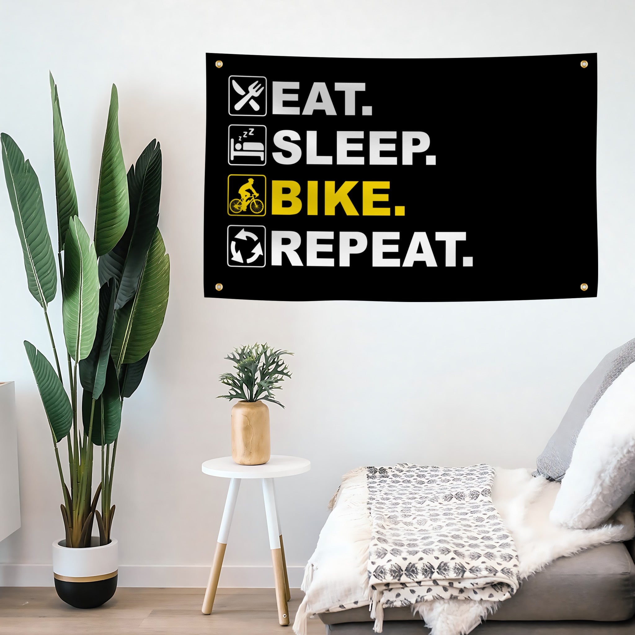 Motivational flag banner with 'Eat. Sleep. Bike. Repeat.' text in a modern living room.