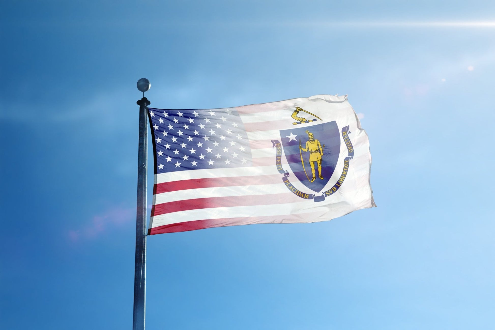 a flag flying in the wind with a blue sky in the background