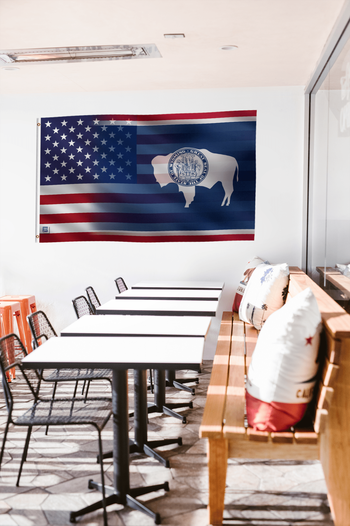 a room with a table, chairs, and a flag hanging on the wall