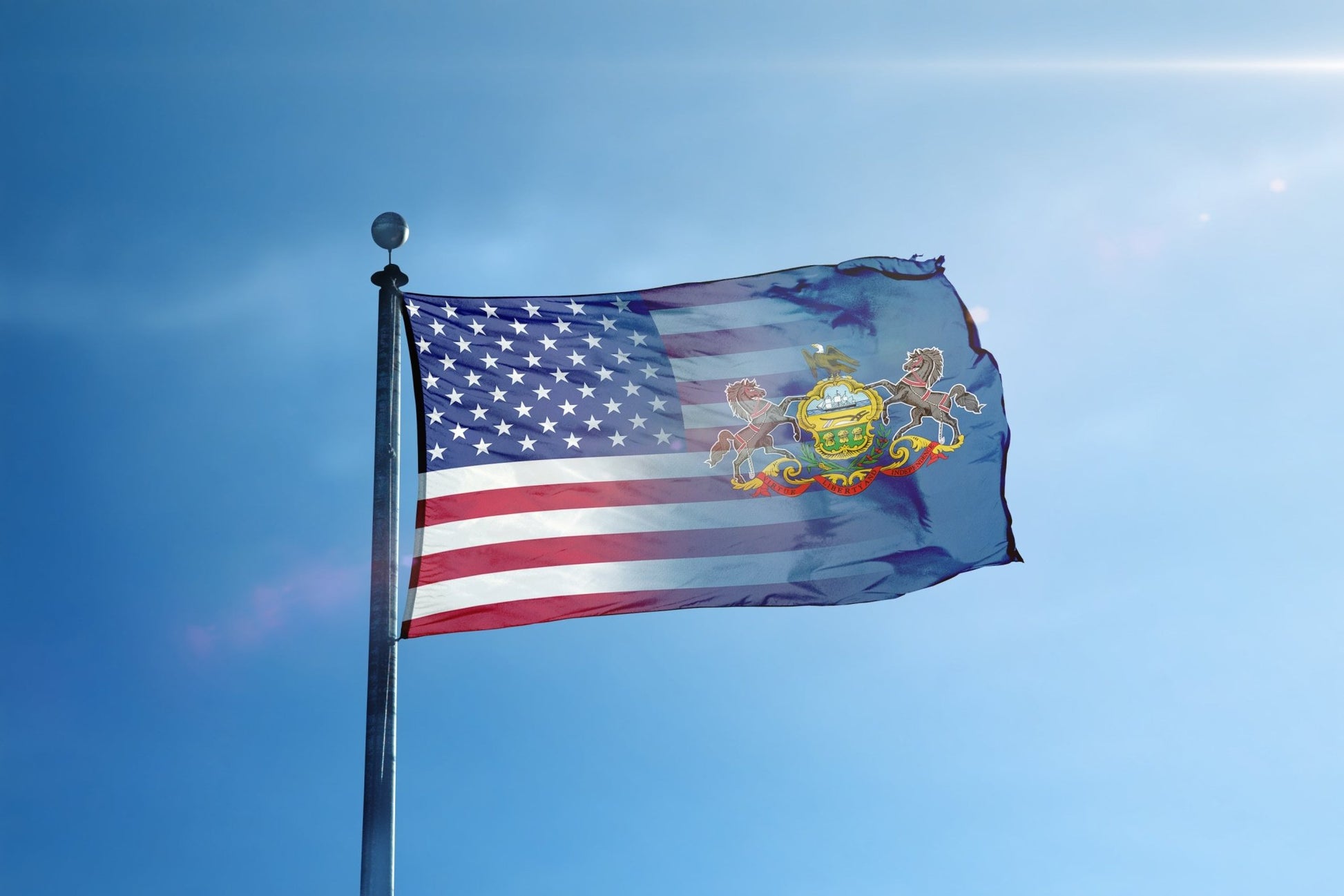 a flag flying in the wind with a blue sky in the background