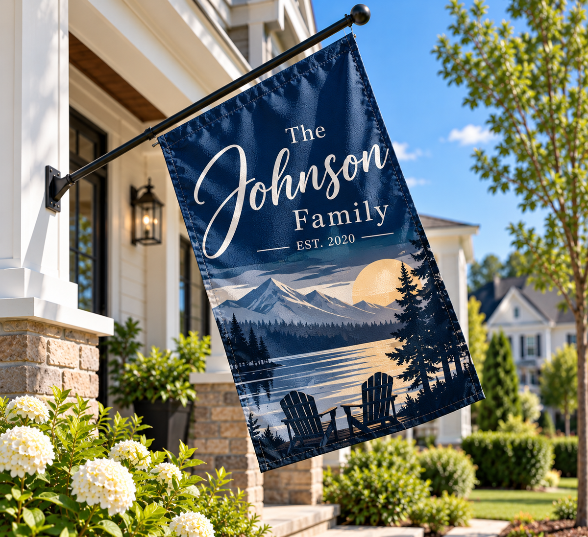 House flag by Bannerfi: navy blue with The Johnson Family EST. 2020, mountain sunset, lake, trees, and two chairs.