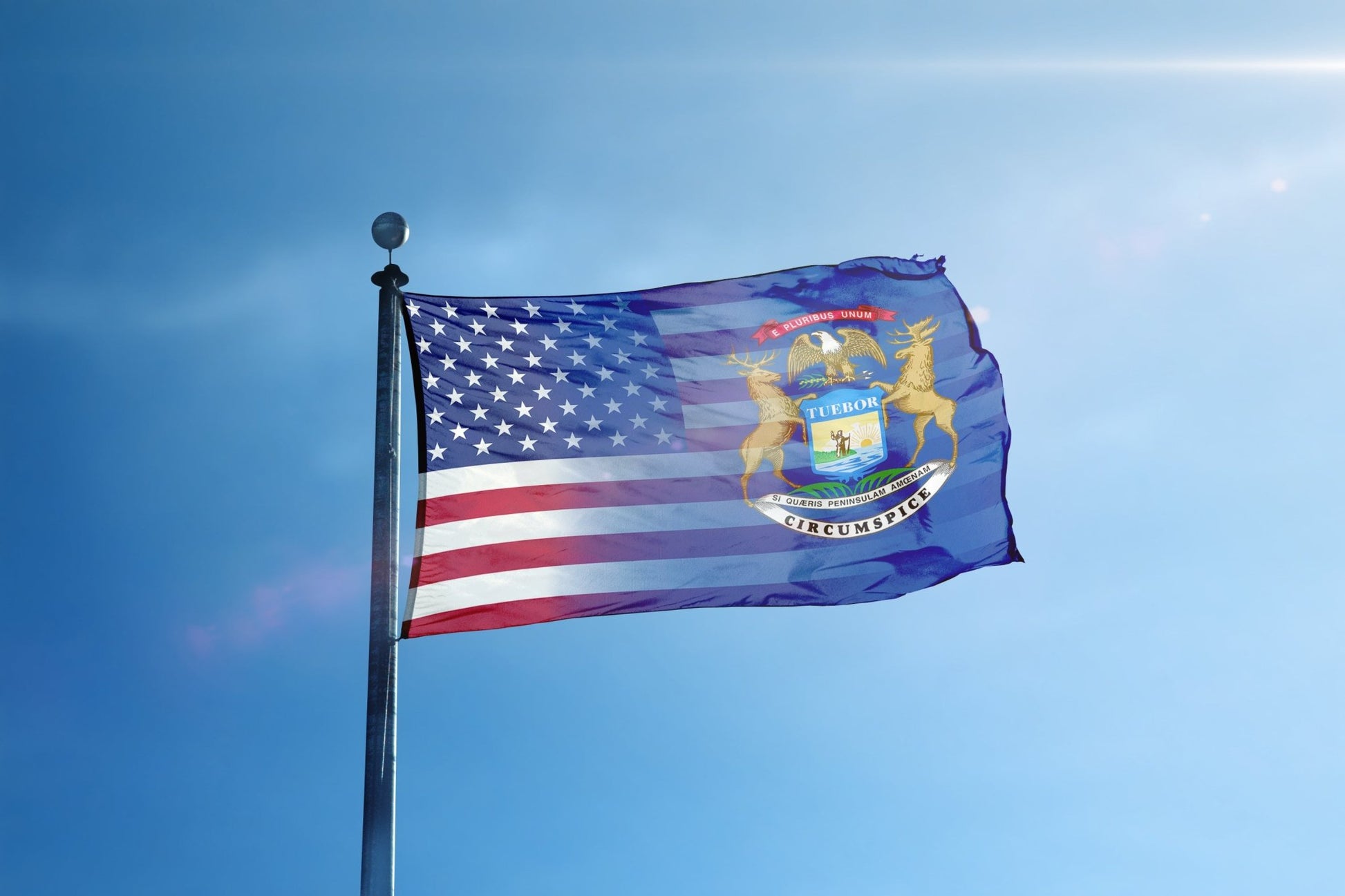 the flag of the state of new york flies high in the blue sky