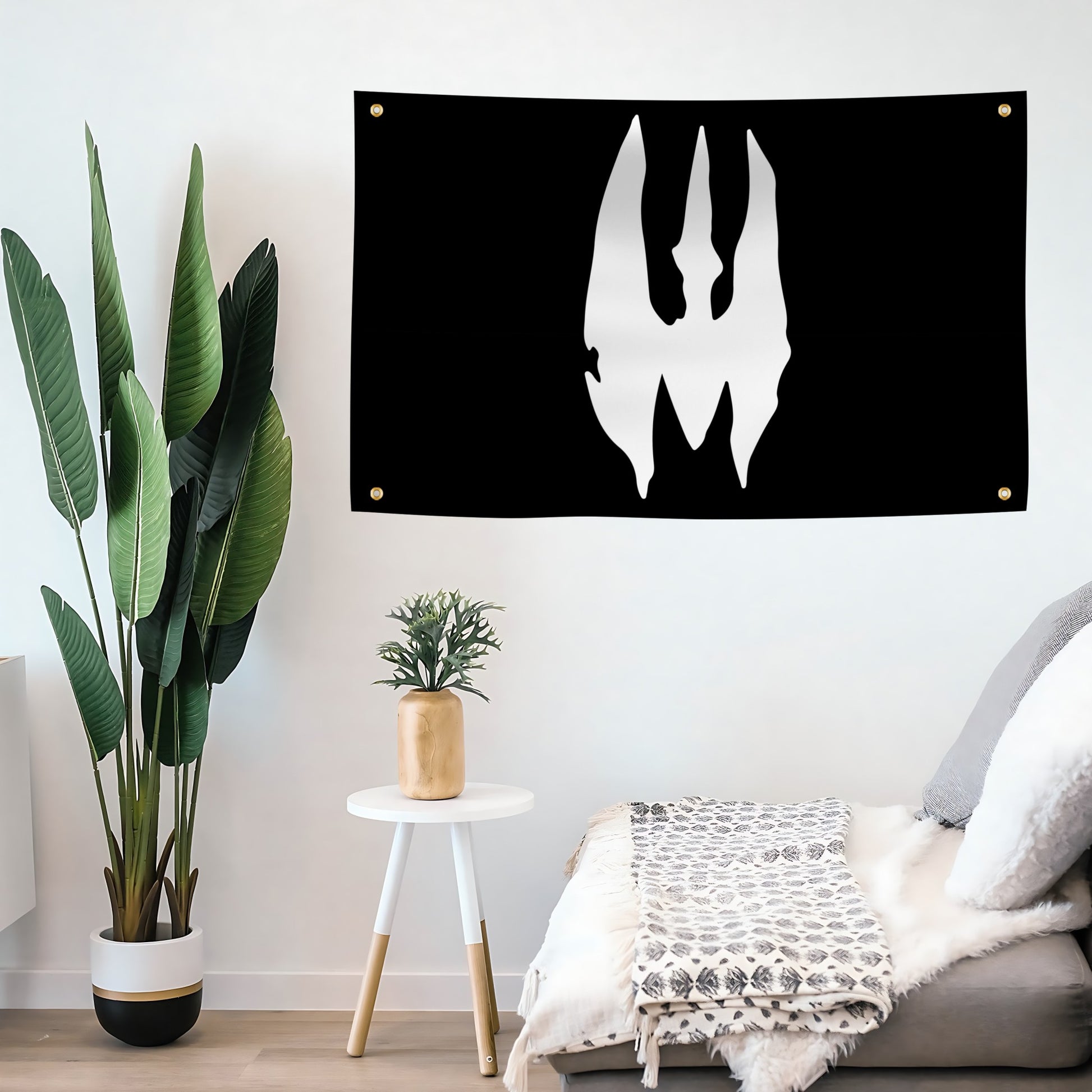 A black flag banner with a white Star Wars Death Watch trident sigil, mounted on a living room wall.