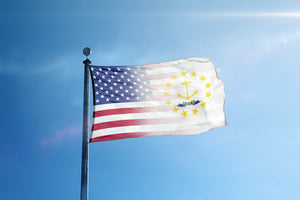 a flag flying in the wind with a blue sky in the background