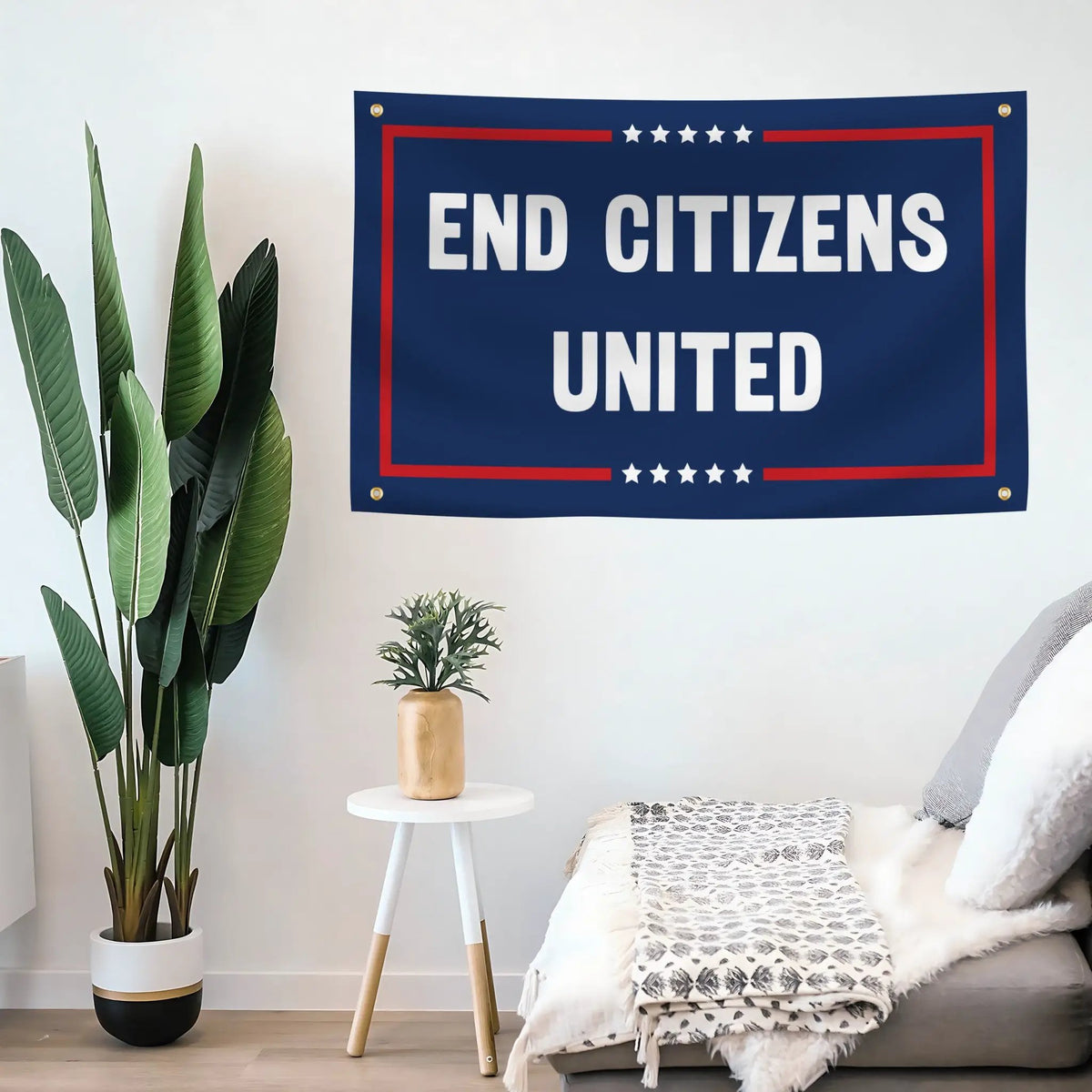 End Citizens United house flag; navy background with bold white text, red border and star accents, hung on a white wall.