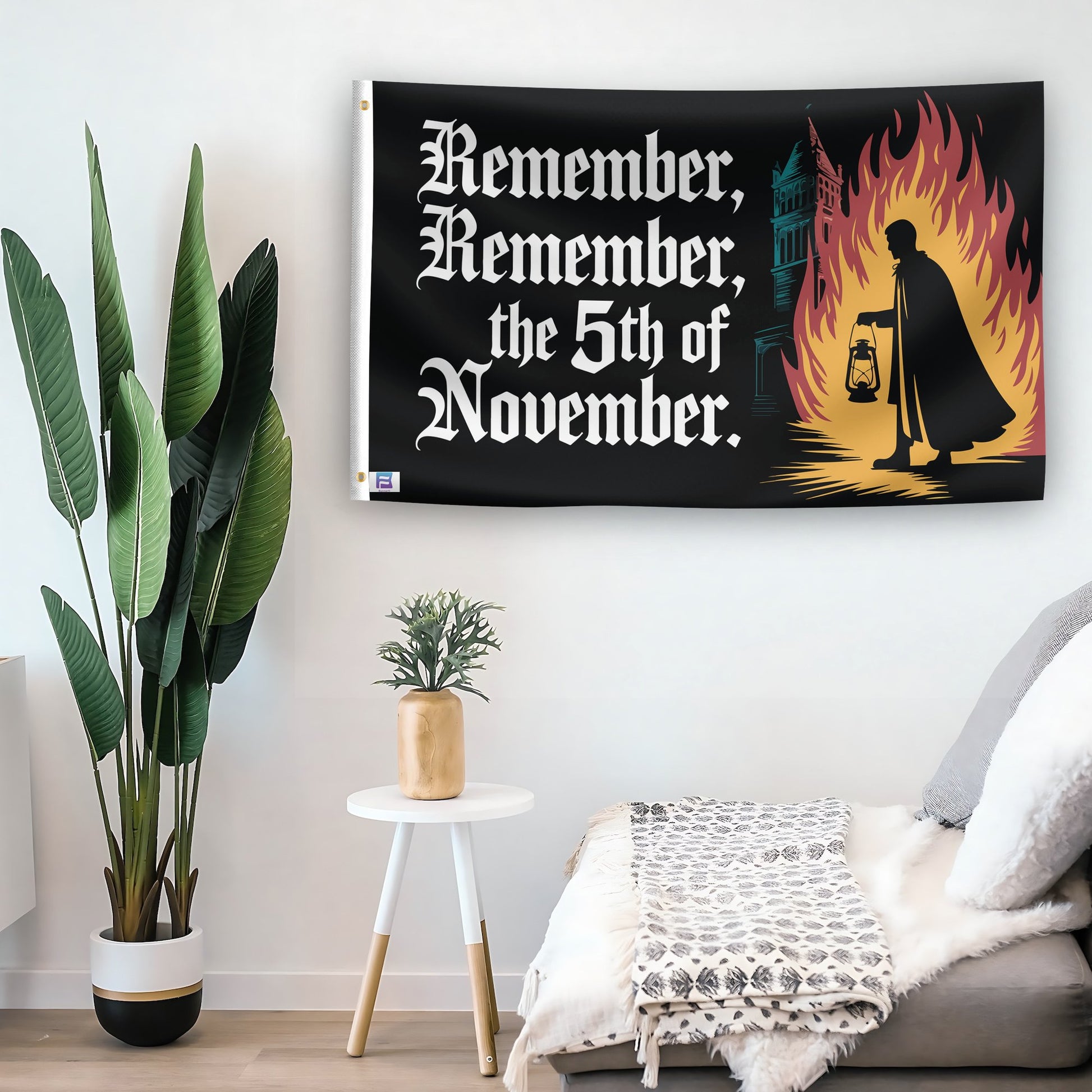 In a home setting, a flag with the saying "Remember Remember The 5th Of November" is mounted on a white wall by a side table.