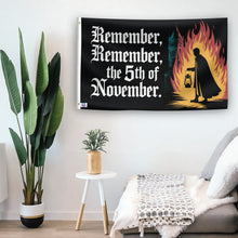 Load image into Gallery viewer, In a home setting, a flag with the saying &quot;Remember Remember The 5th Of November&quot; is mounted on a white wall by a side table.
