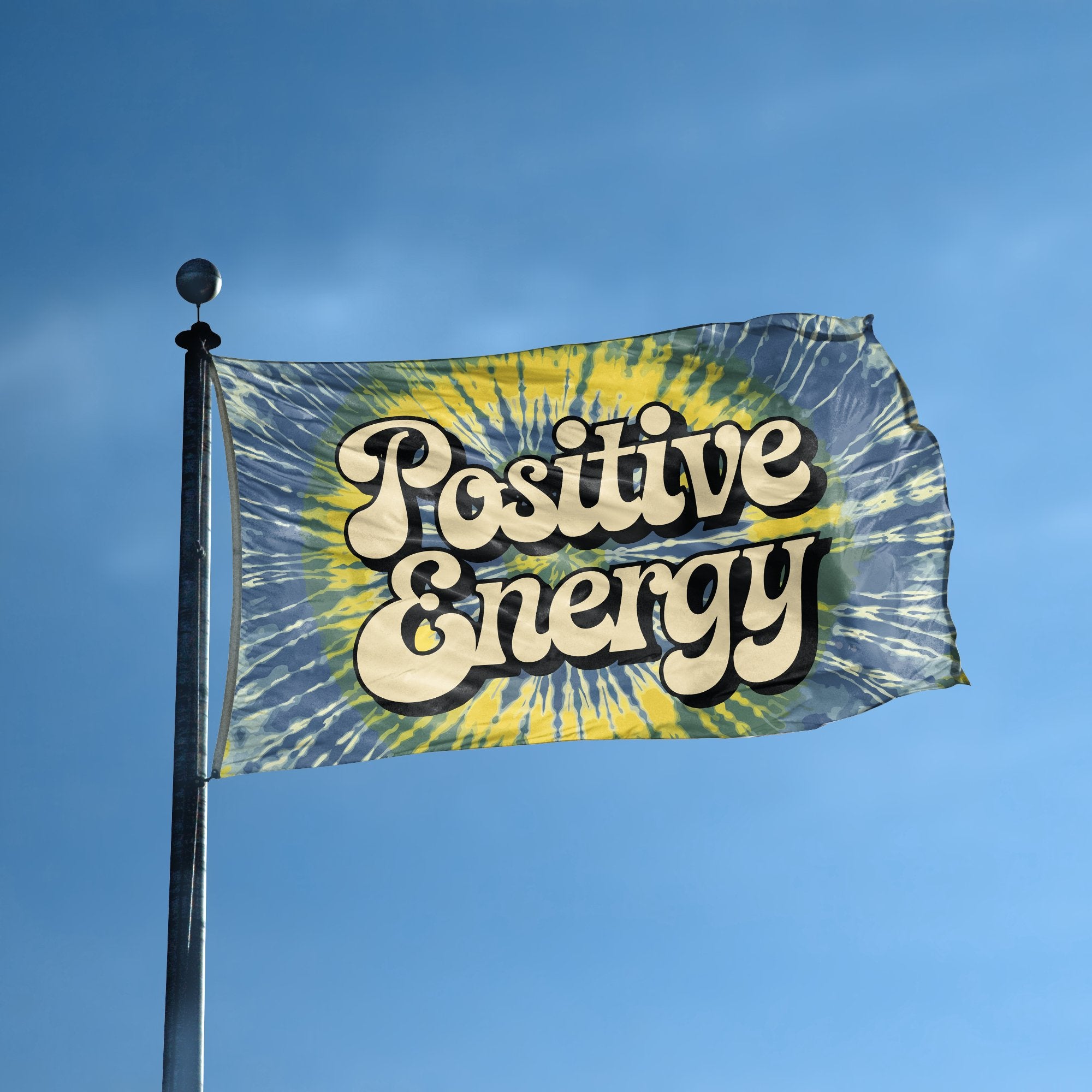 A flag with the saying "Positive Energy" displayed on a high pole, with a tie dye style color scheme.