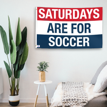 Load image into Gallery viewer, In a home setting, a flag with the saying &quot;https://www.dropbox.com/scl/fi/gtekcy7picz4257v74zzc/saturdays-are-for-soccer_room.png?rlkey=zr5wqutdxavpojo1j5rybv42b&amp;raw=1&quot; is mounted on a white wall by a side table.
