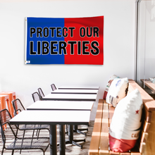 Load image into Gallery viewer, A political flag in royal blue and crimson red with a political statement on a wall in a cafe setting.
