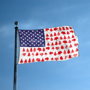 An american flag with the red stripes changed to match the theme "Tree Stripes American" displayed on a high pole.