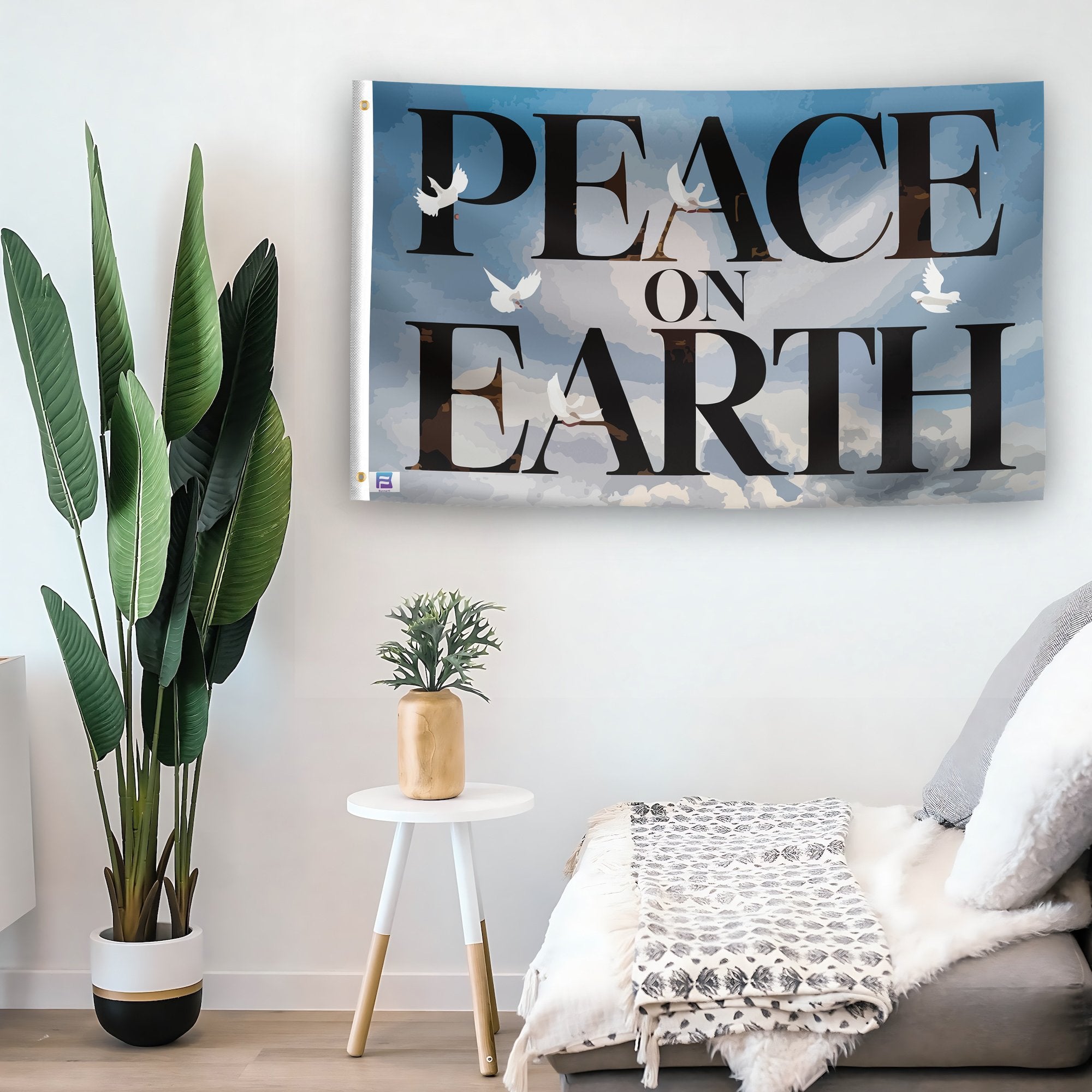 In a home setting, a flag with the saying "Peace On Earth Inspirational" is mounted on a white wall by a side table.