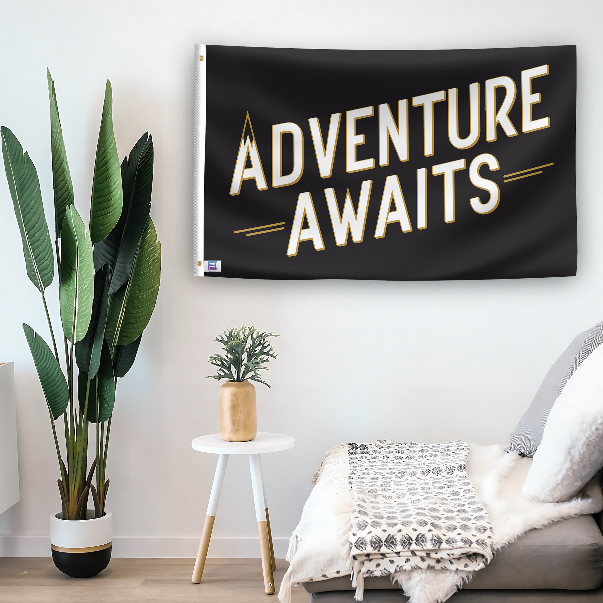 In a home setting, a flag with the saying "Adventure Awaits You" is mounted on a white wall by a side table.